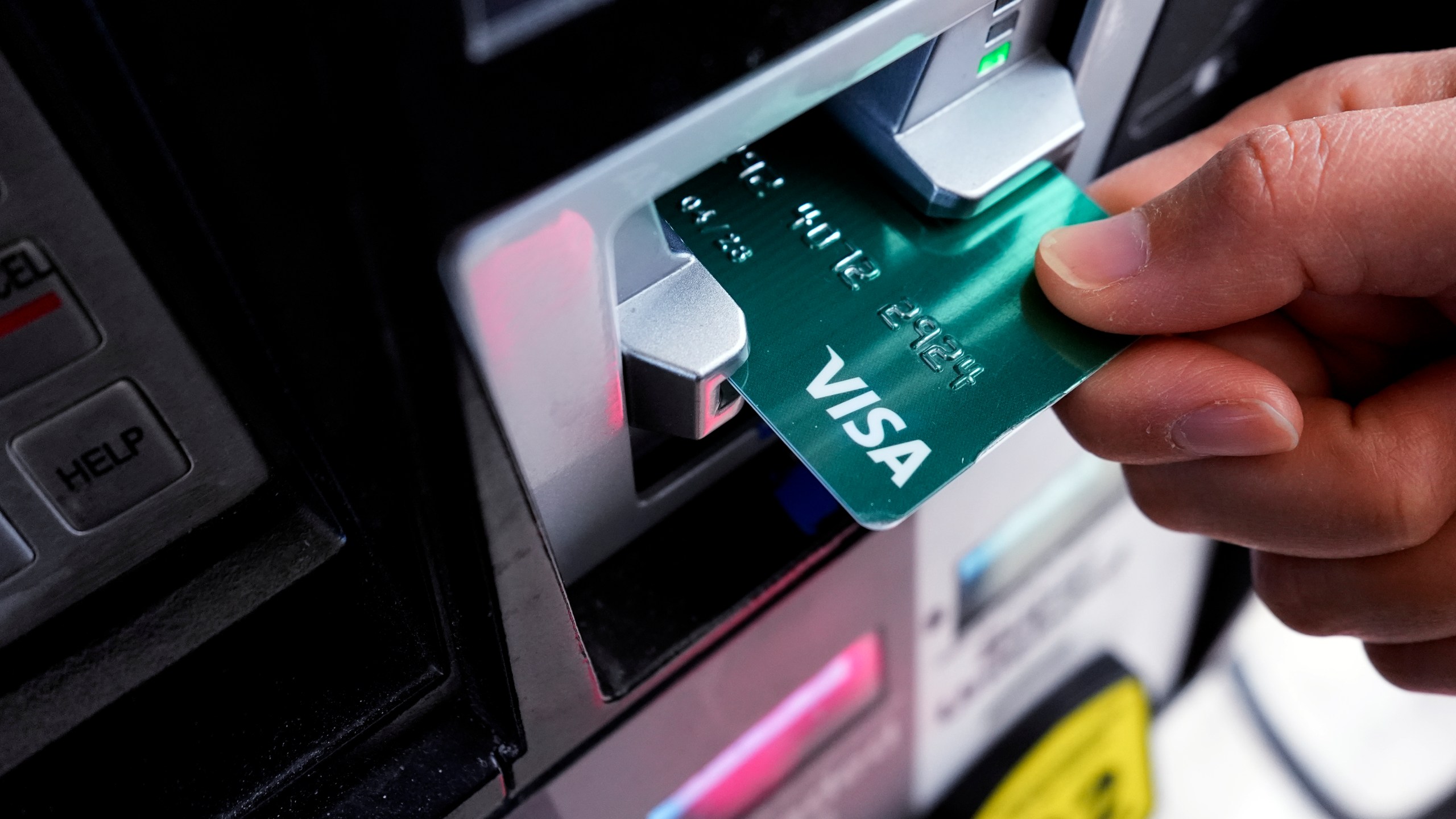 FILE - A customer uses a Visa credit card to pay for gasoline at a gas station in Mundelein, Ill., Feb. 8, 2024. (AP Photo/Nam Y. Huh)