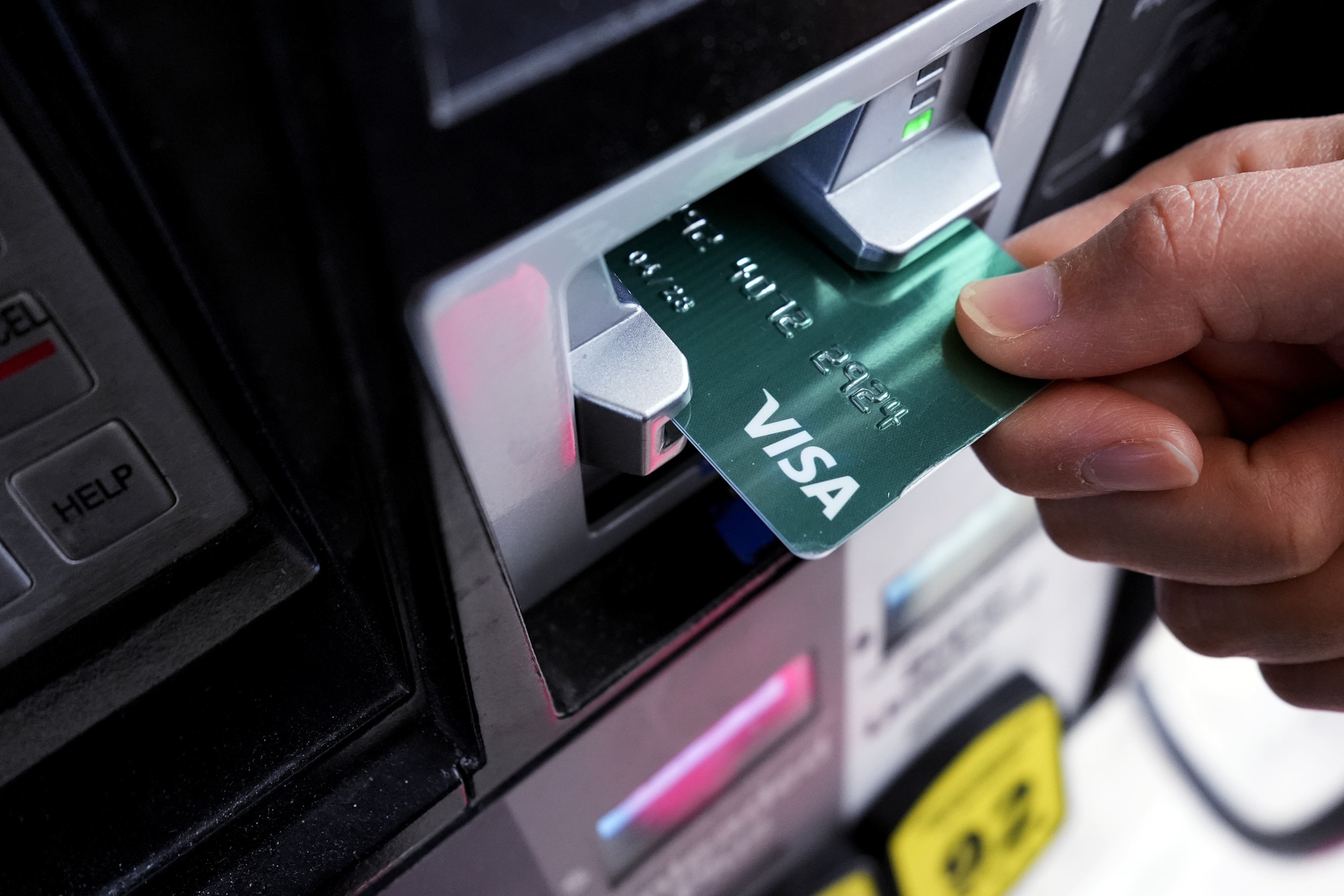 FILE - A customer uses a Visa credit card to pay for gasoline at a gas station in Mundelein, Ill., Feb. 8, 2024. (AP Photo/Nam Y. Huh)