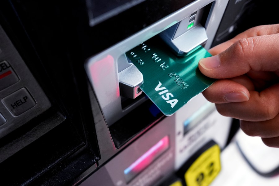 FILE - A customer uses a Visa credit card to pay for gasoline at a gas station in Mundelein, Ill., Feb. 8, 2024. (AP Photo/Nam Y. Huh)