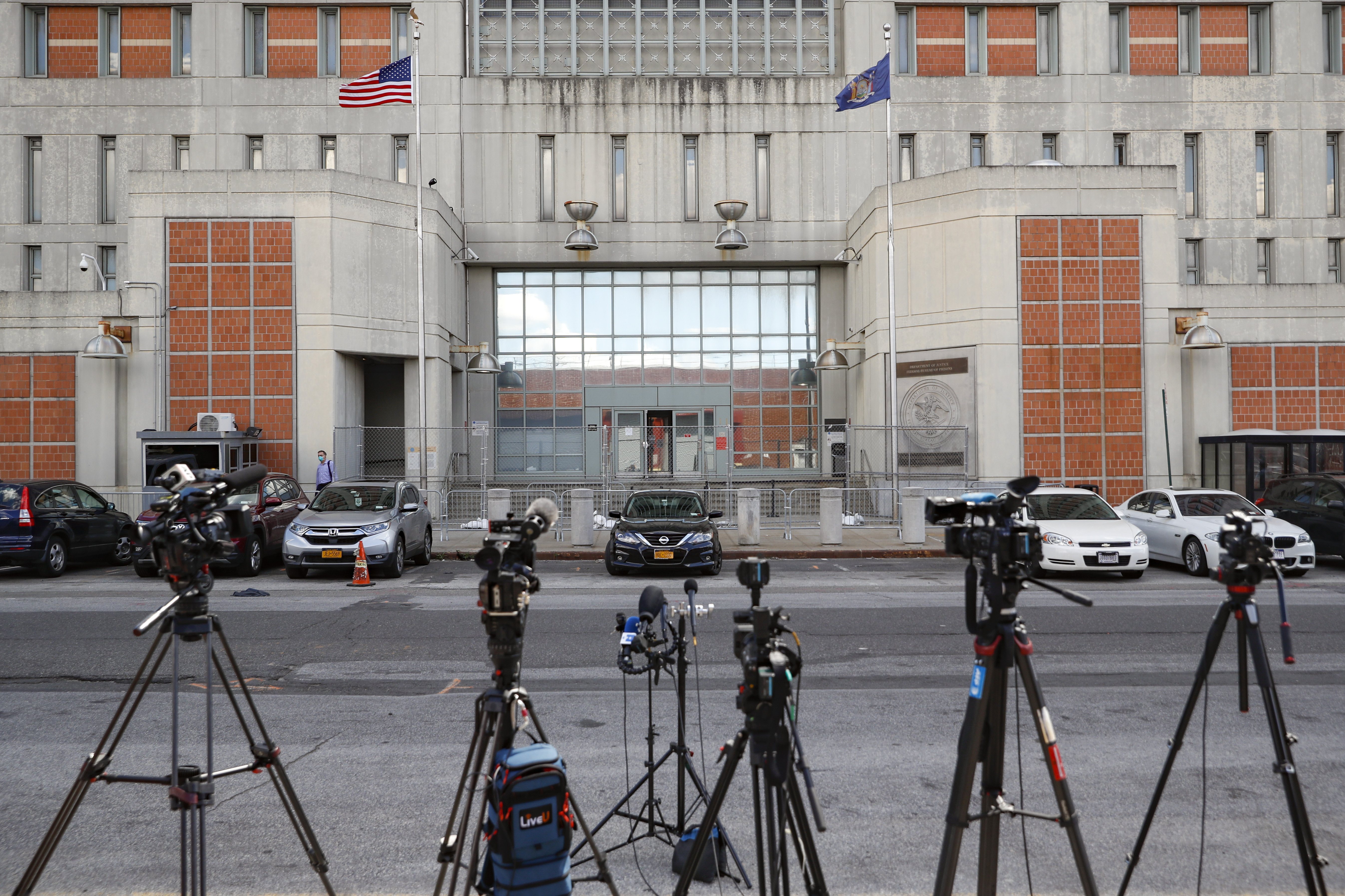 FILE - Media outlets set up cameras outside the main entrance of the Metropolitan Detention Center Tuesday, July 14, 2020, in the Brooklyn borough of New York. (AP Photo/John Minchillo, File)