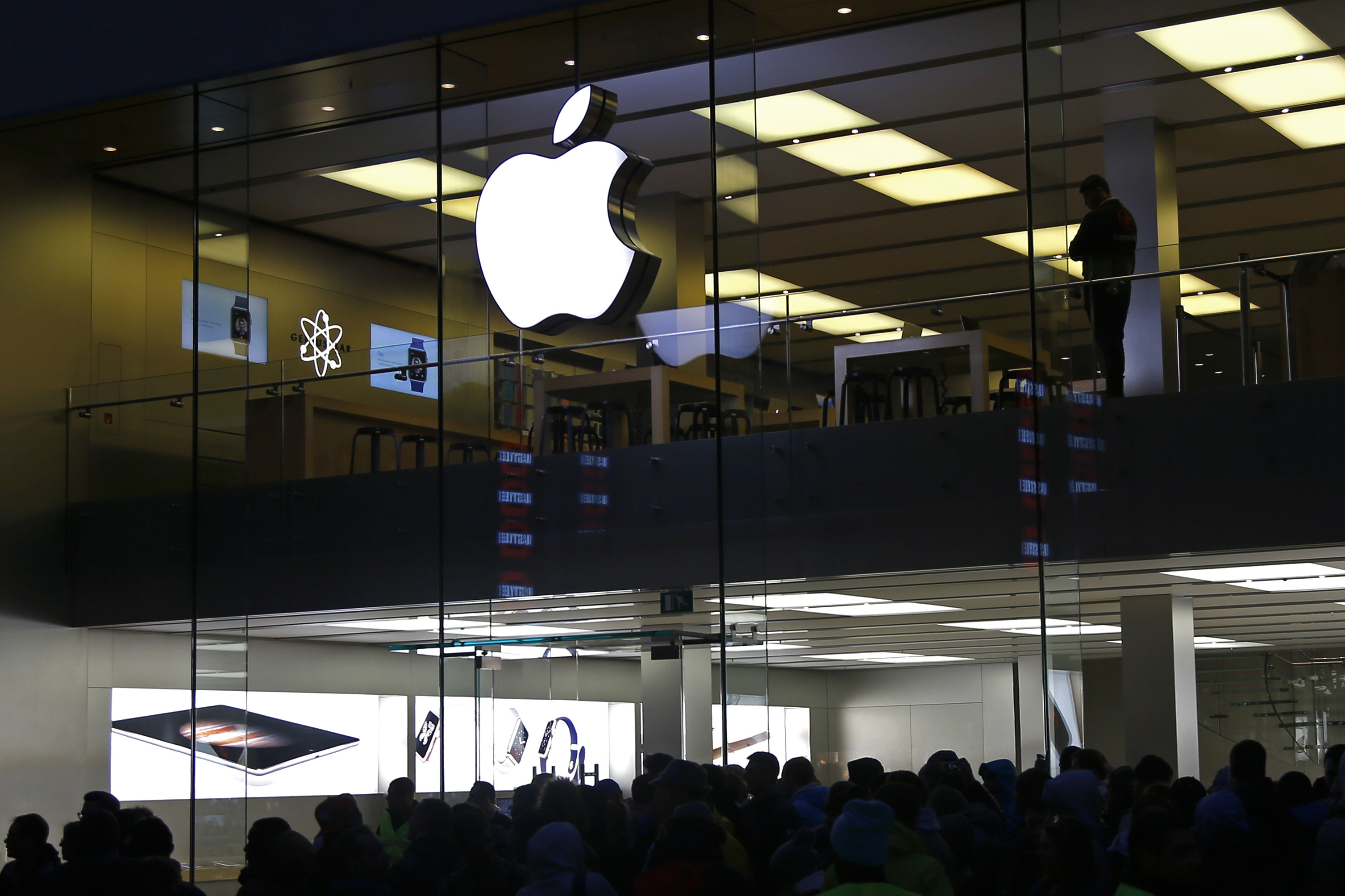 FILE - People wait in front of the Apple store in Munich, Germany, on Sept. 25, 2015. The European Union’s top court has rejected Apple’s final legal challenge against an order from the bloc’s executive commission to repay 13 billion euros in back taxes to Ireland, bringing an end to the long-running dispute (AP Photo/Matthias Schrader, File)