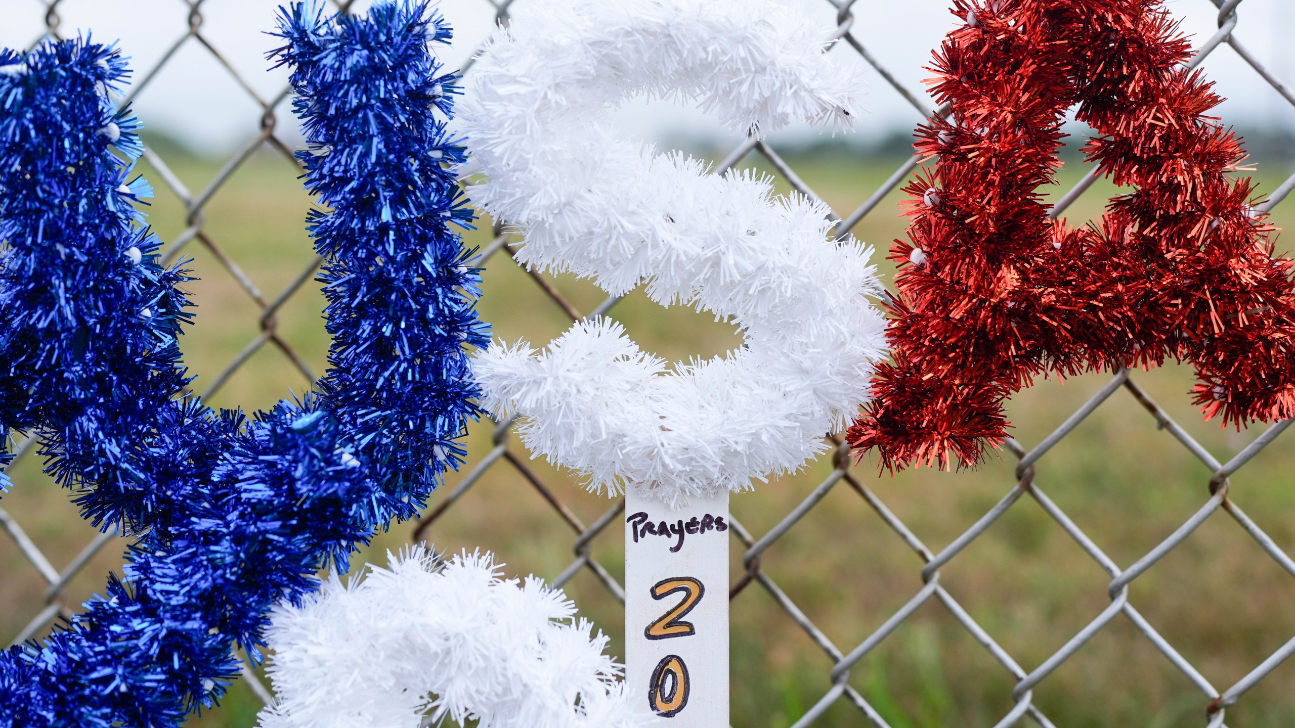 FILE - A memorial rest along a fence outside the Butler Farm Show in Butler, Pa., July 17, 2024, the site where firefighter Corey Comperatore died and Republican presidential candidate former President Donald Trump was wounded, when a gunman opened fire on the rally. (AP Photo/Eric Gay, File)