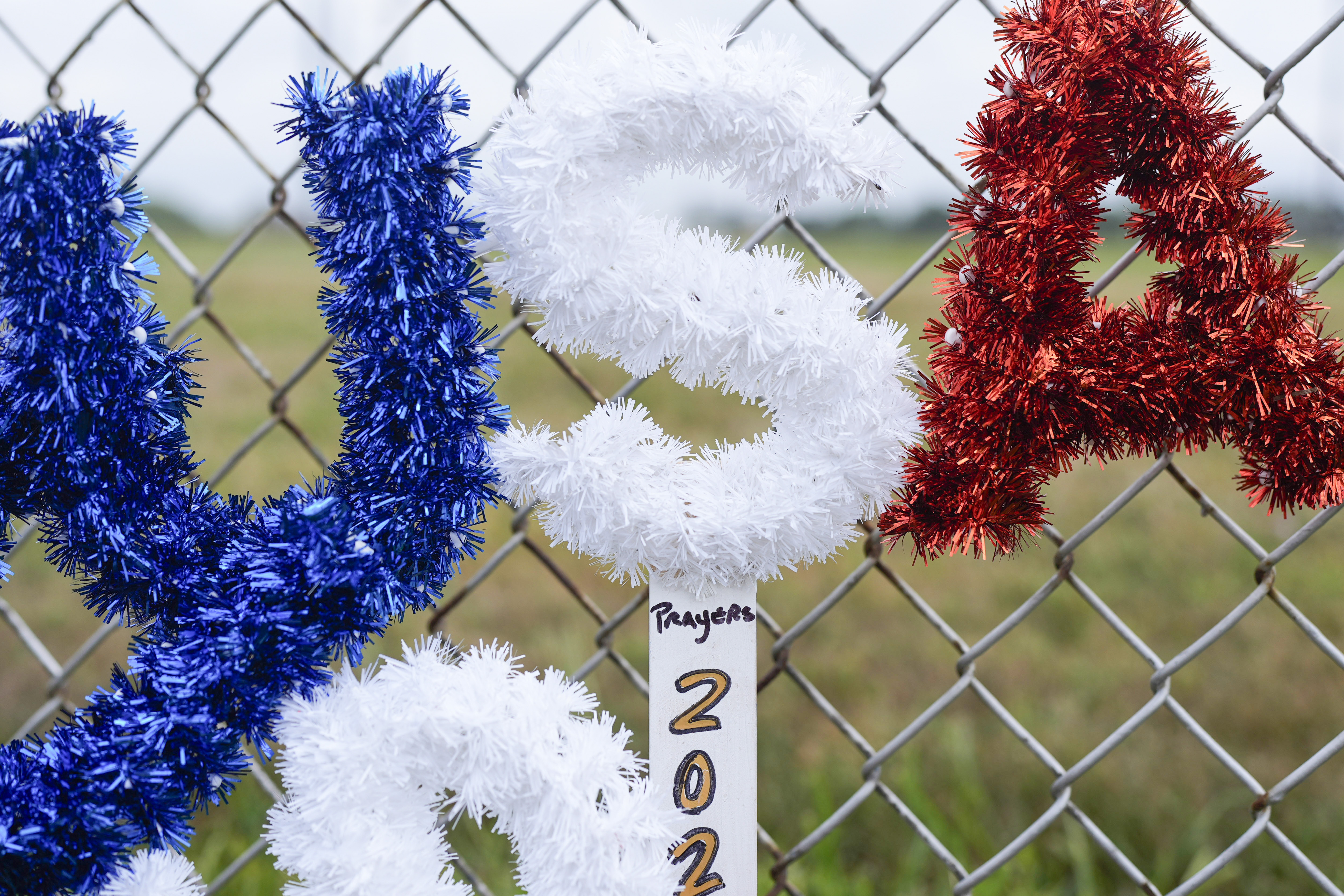 FILE - A memorial rest along a fence outside the Butler Farm Show in Butler, Pa., July 17, 2024, the site where firefighter Corey Comperatore died and Republican presidential candidate former President Donald Trump was wounded, when a gunman opened fire on the rally. (AP Photo/Eric Gay, File)