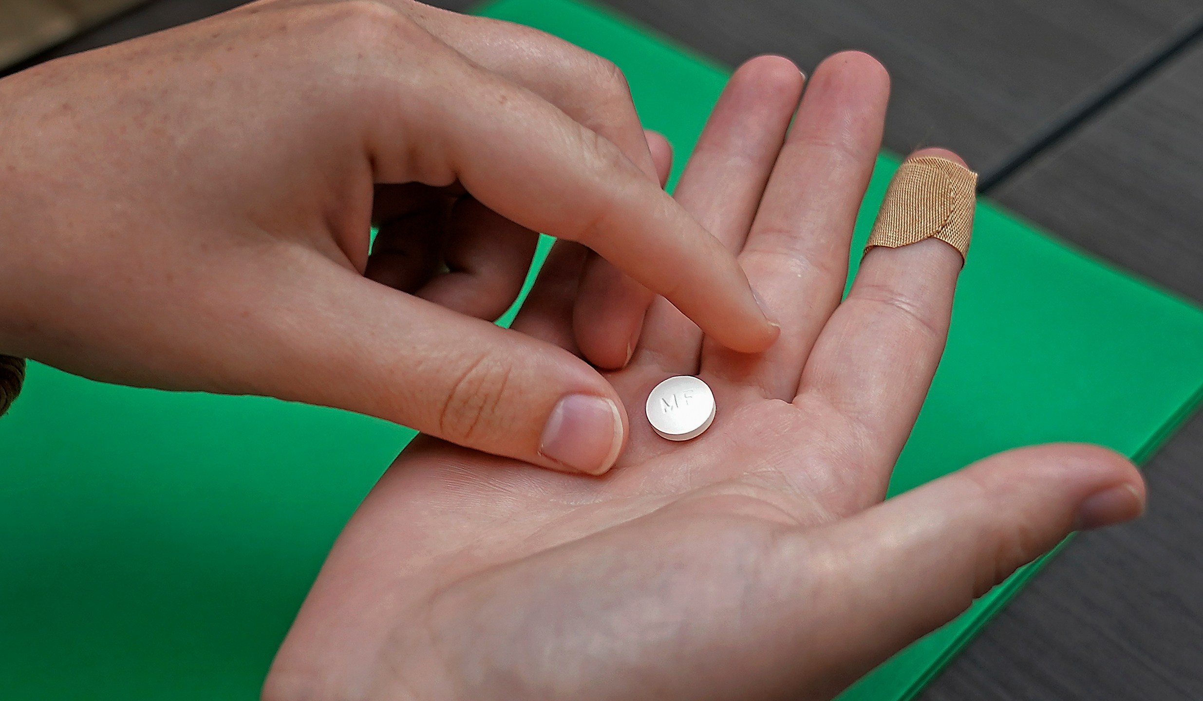 FILE - A patient prepares to take the first of two combination pills, mifepristone, for a medication abortion during a visit to a clinic in Kansas City, Kan., on, Oct. 12, 2022. (AP Photo/Charlie Riedel, File)