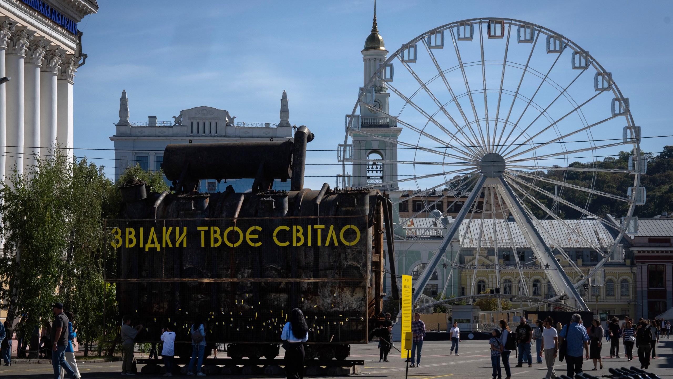 People look at a burnt transformer from one of power plants badly damaged in one of Russia's recent missile attacks on energy system in Kyiv, Ukraine, Thursday, Sept. 19, 2024. (AP Photo/Efrem Lukatsky)