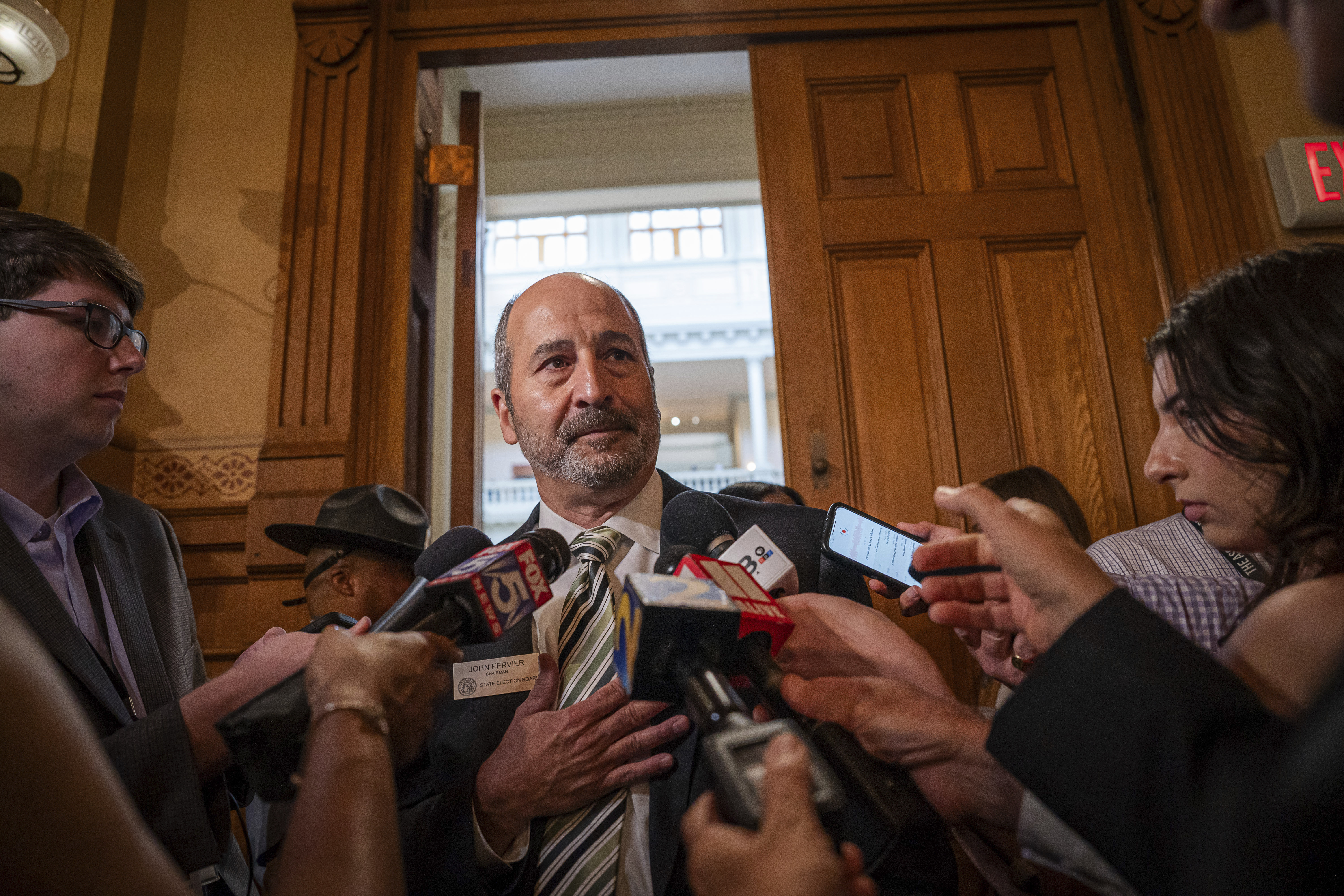 FILE - John Fervier, Chairman of the State Election Board, takes questions from the media during a brief recess during a meeting at the Capitol in Atlanta, Aug. 6, 2024. (Matthew Pearson/WABE via AP, File)