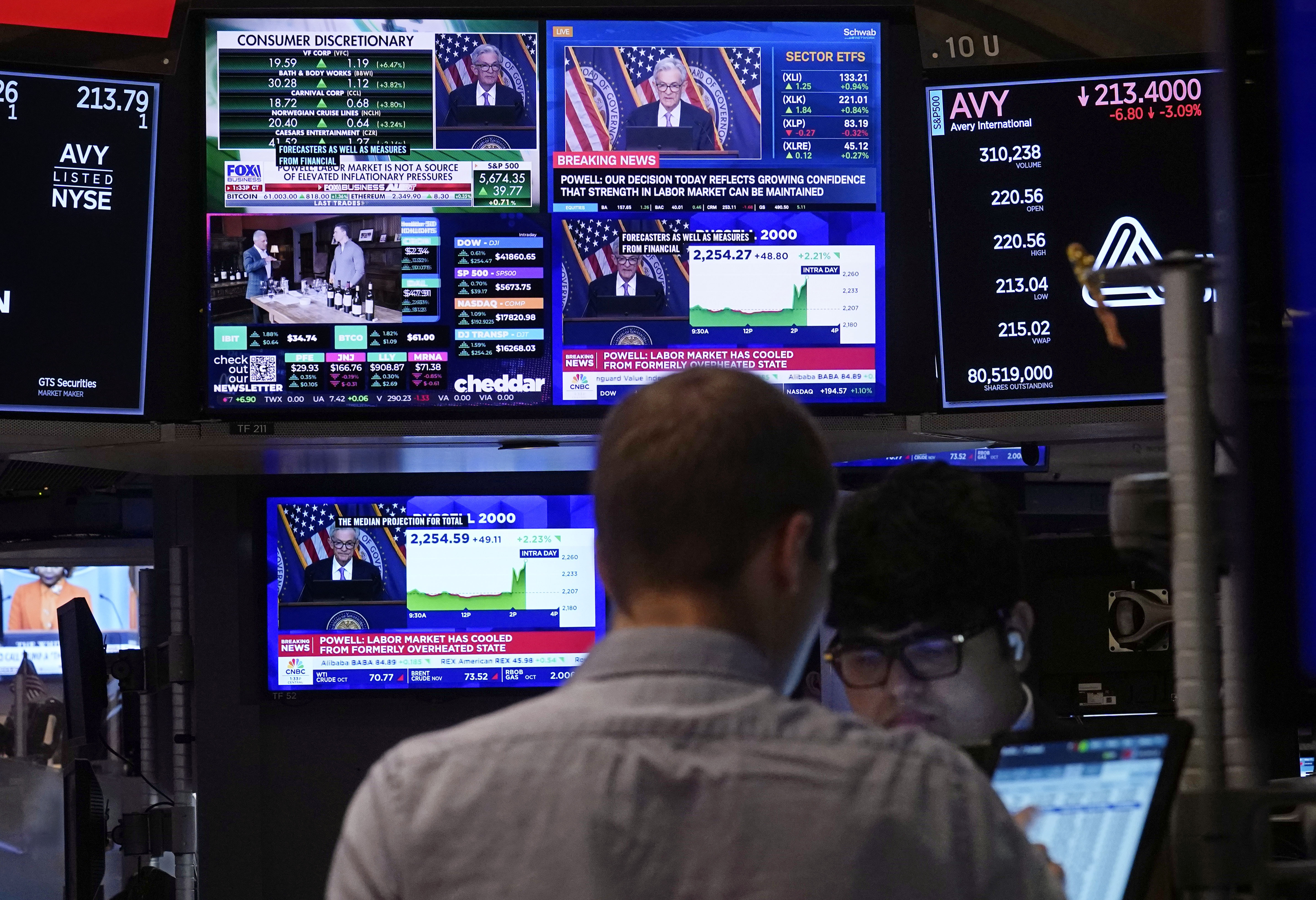 The news conference of Federal Reserve Chair Jerome Powell appears on television screens on the floor of the New York Stock Exchange, Wednesday, Sept. 18, 2024. (AP Photo/Richard Drew)