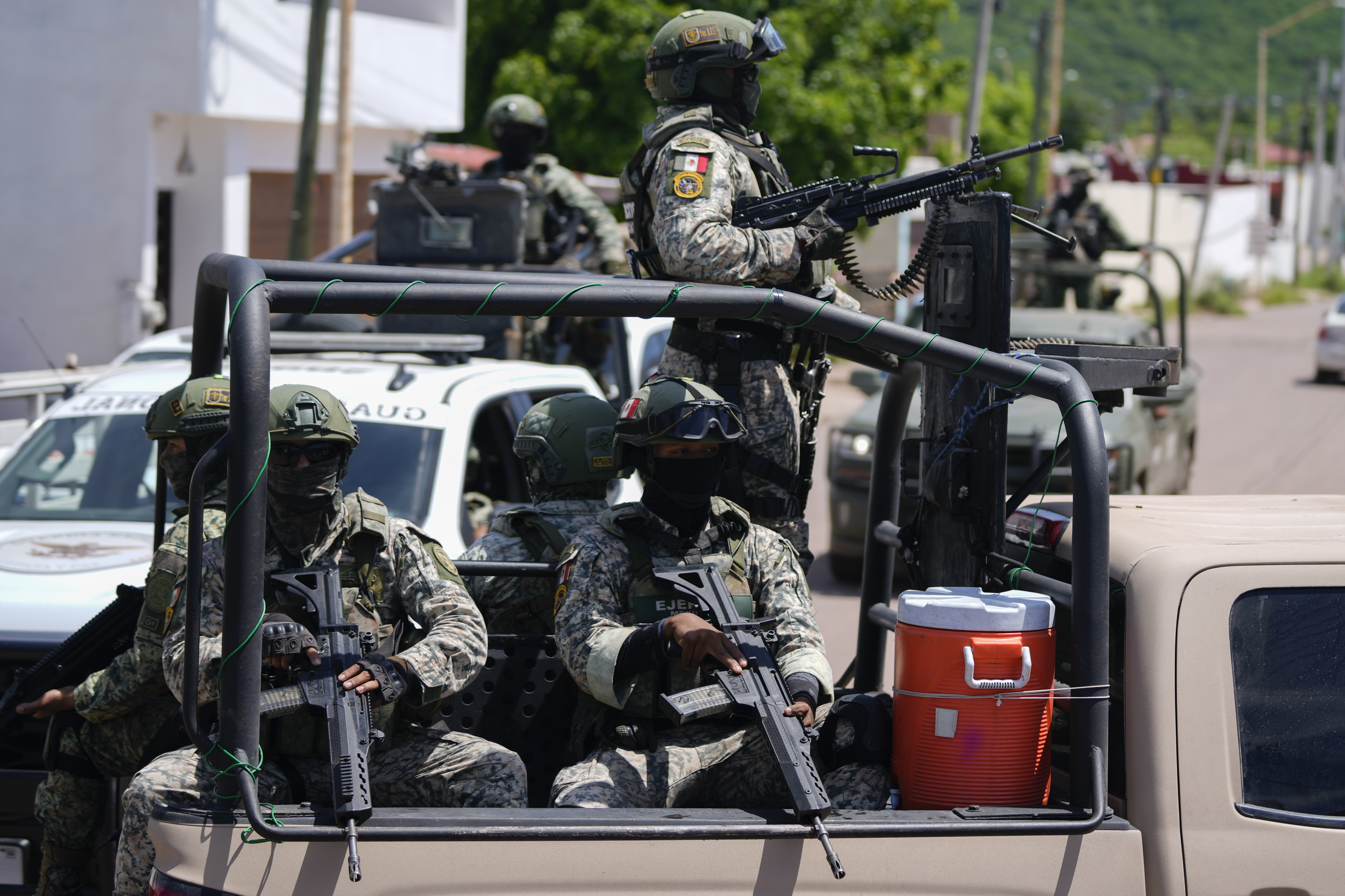 National Guards and Army forces patrol the streets during an operation in a neighborhood of Culiacan, Sinaloa state, Mexico, Thursday, Sept. 19, 2024. (AP Photo/Eduardo Verdugo)