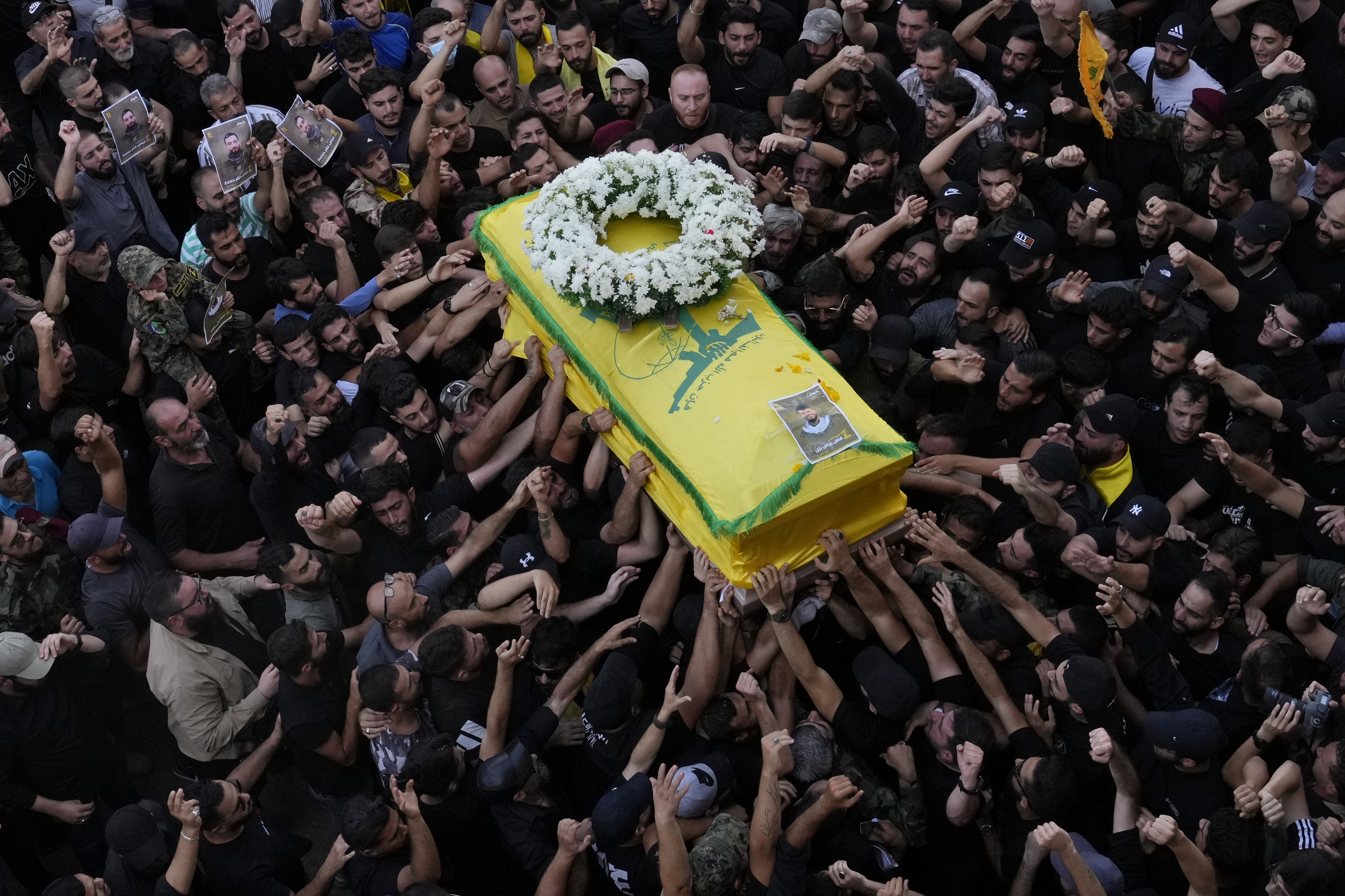 Hezbollah members carry the coffin of their comrade who was killed when a handheld device exploded, during a funeral procession in the southern suburbs of Beirut, Thursday, Sept. 19, 2024. (AP Photo/Hussein Malla)