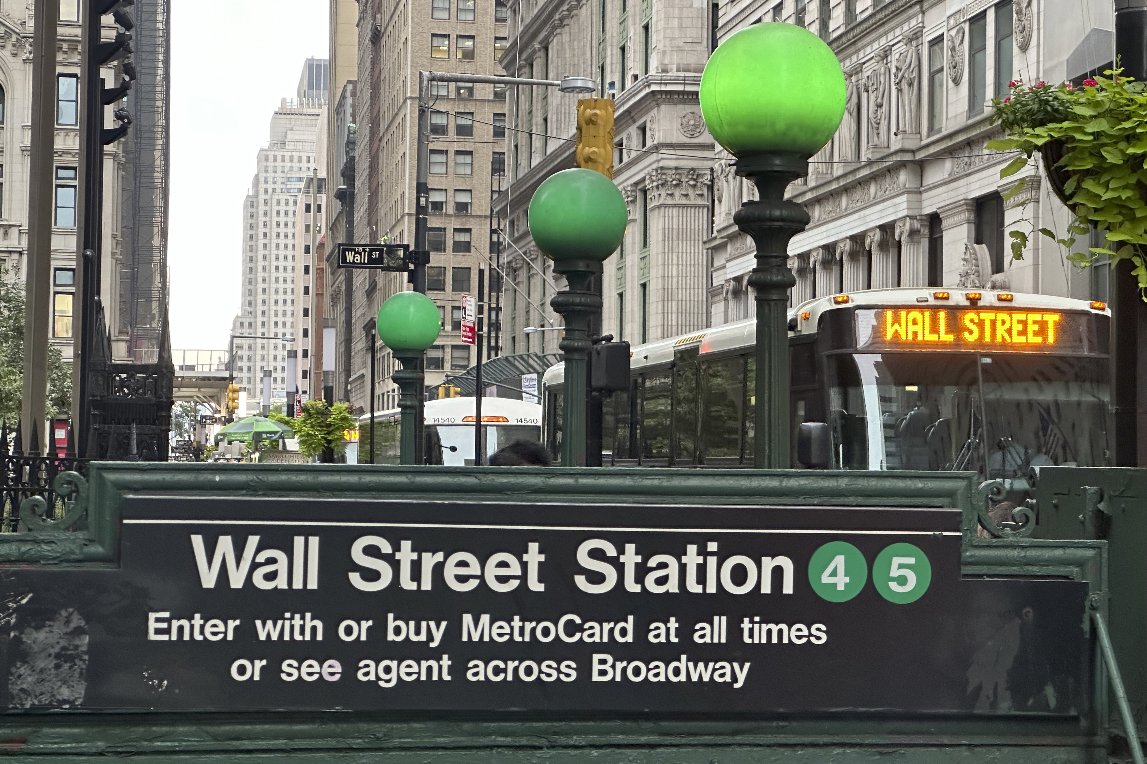 A bus passes the Wall St. subway station on Wednesday, Sept. 18, 2024, in New York. (AP Photo/Peter Morgan)