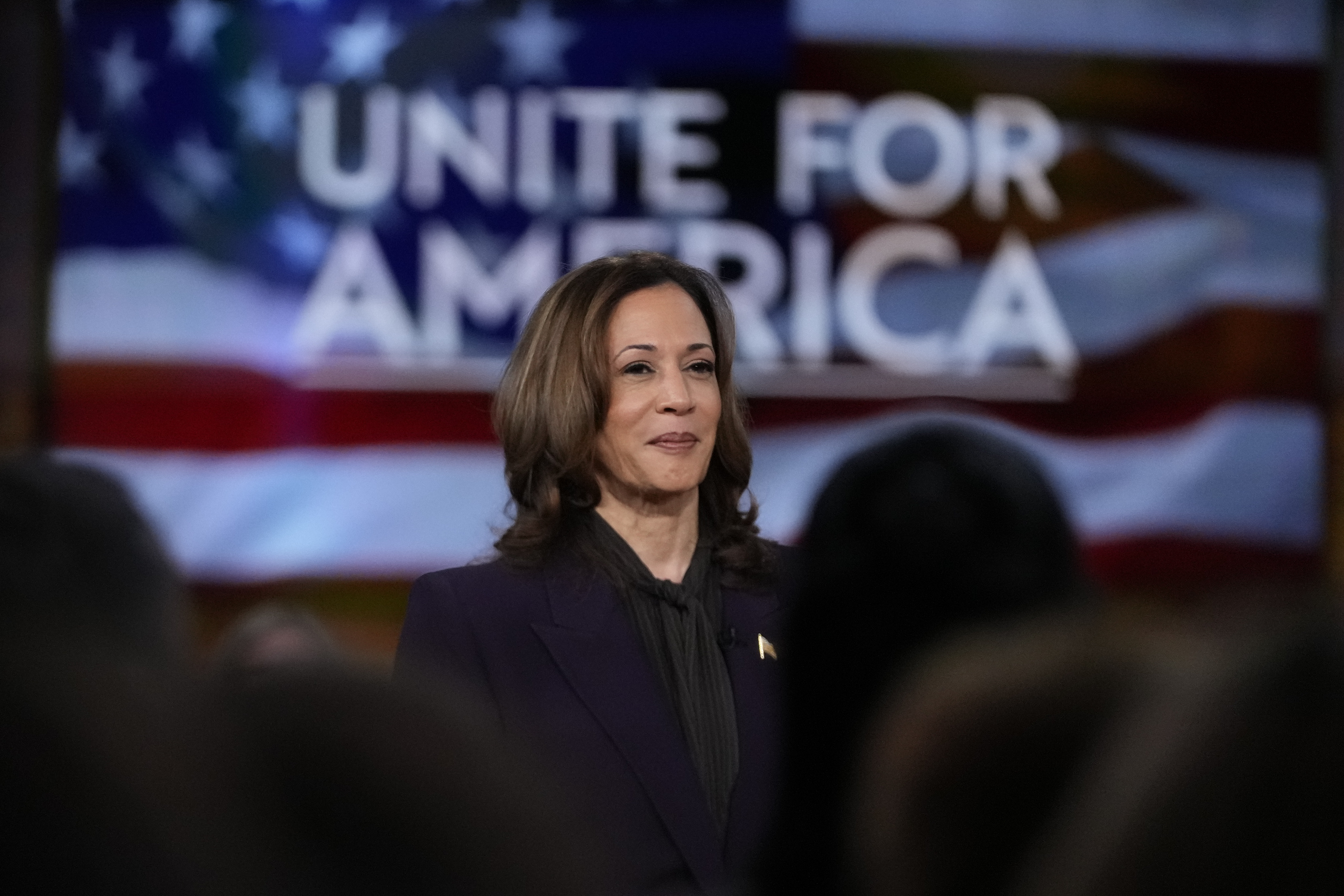 Democratic presidential nominee Vice President Kamala Harris listens as she joins Oprah Winfrey at Oprah's Unite for America Live Streaming event Thursday, Sept. 19, 2024 in Farmington Hills, Mich. (AP Photo/Paul Sancya)