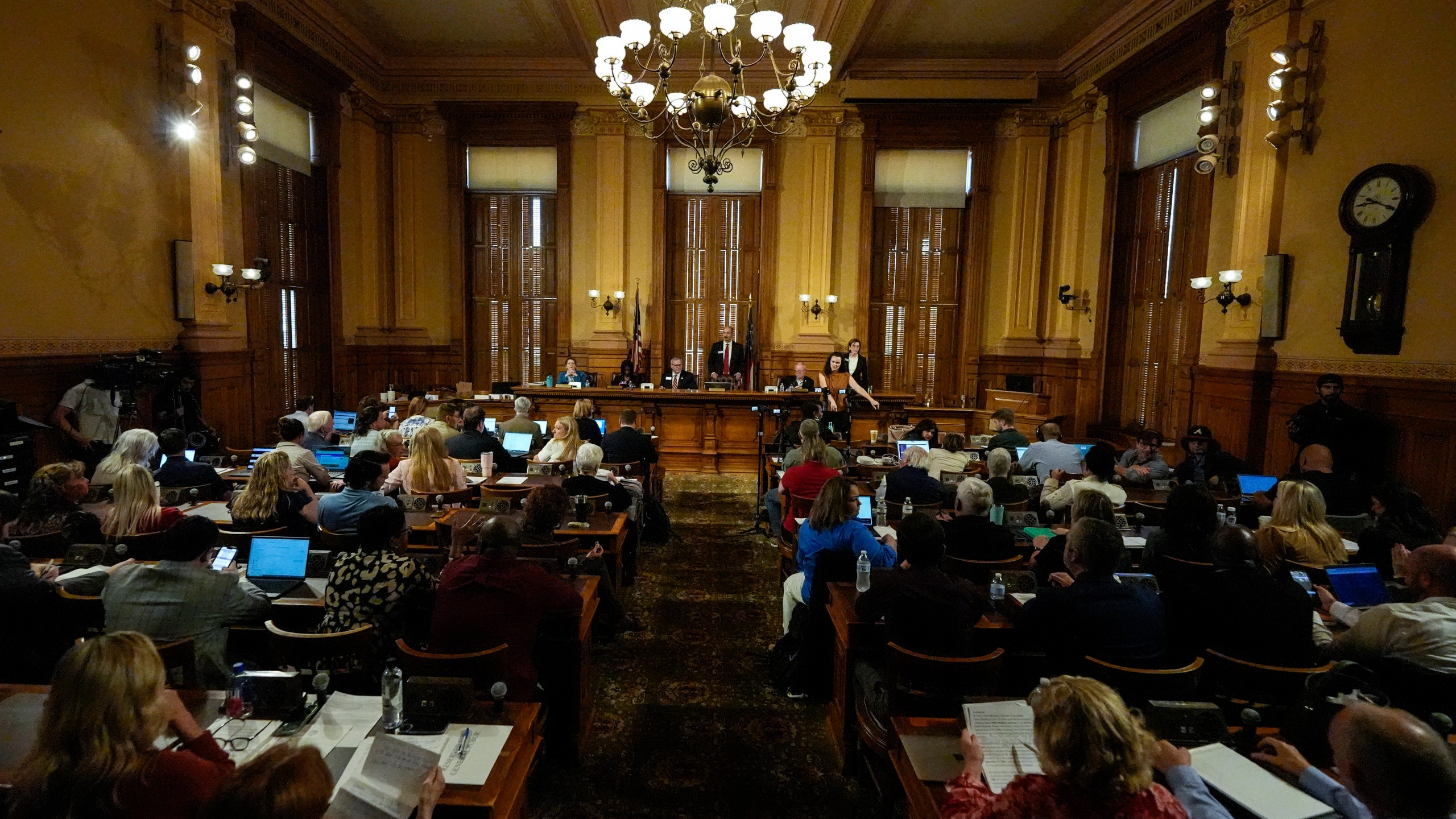 Georgia's State Election Board members discuss proposals to a full room for election rule changes at the state capitol, Friday, Sept. 20, 2024, in Atlanta. (AP Photo/Mike Stewart)