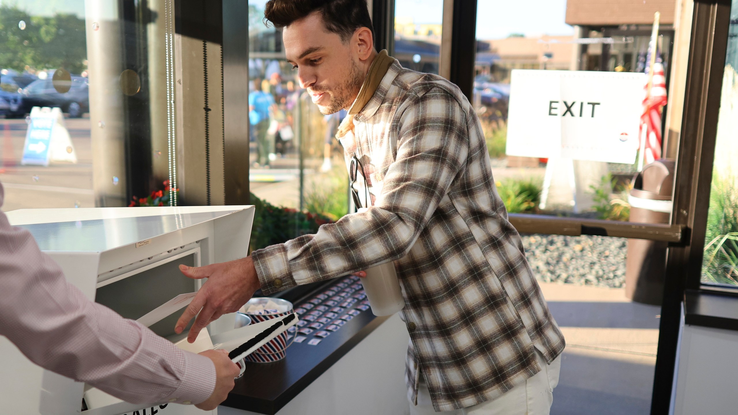 Minneapolis voter Jason Miller casts his ballot at the City of Minneapolis early voting center, Friday, September 20, 2024, in Minneapolis, Minn. Miller was the first resident in line to cast his vote. (AP Photo/Adam Bettcher)