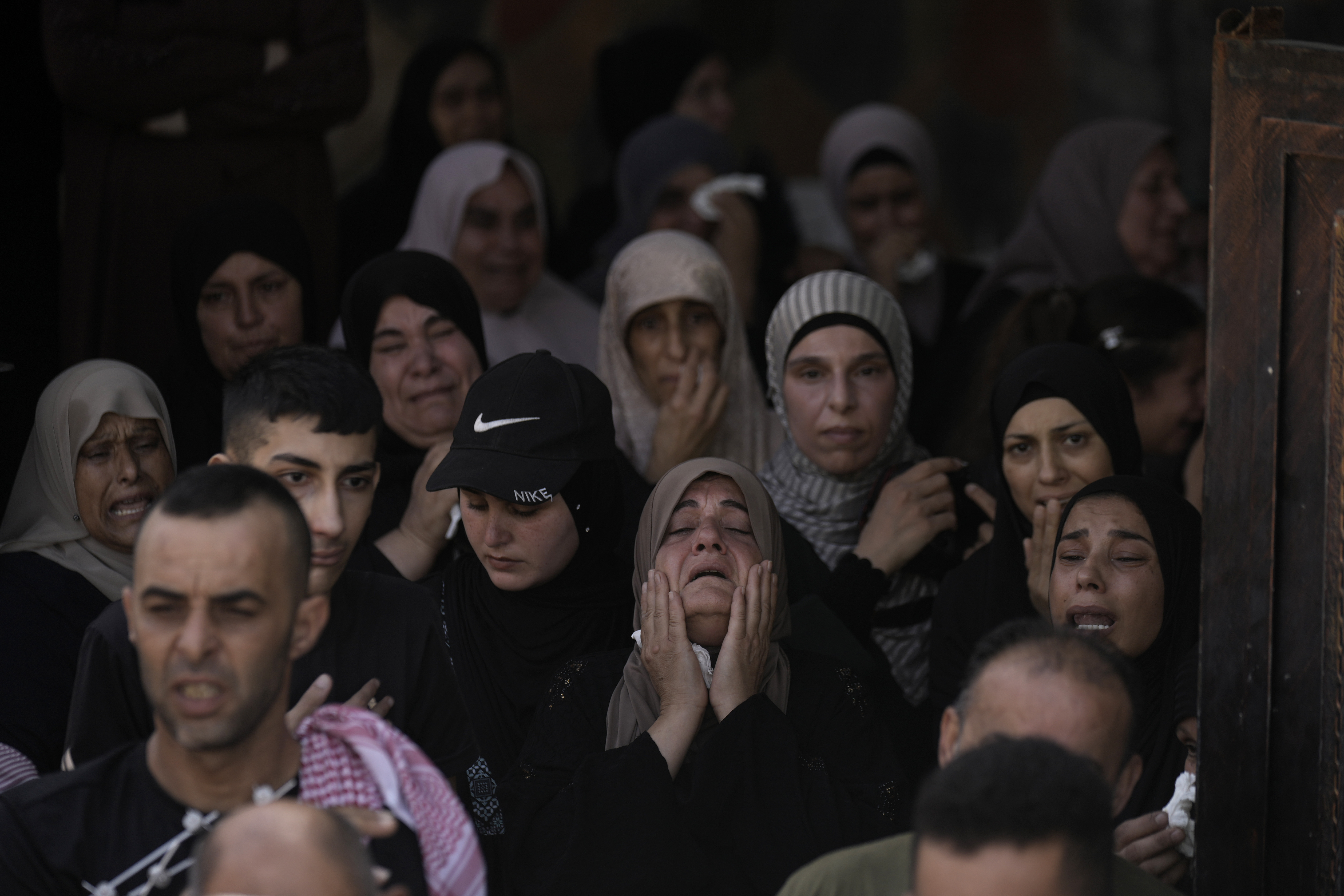 A woman grieves during the funeral for three Palestinian militants killed in an Israeli military operation in the West Bank town of Qabatiya, Friday, Sept. 20, 2024. (AP Photo/Majdi Mohammed)