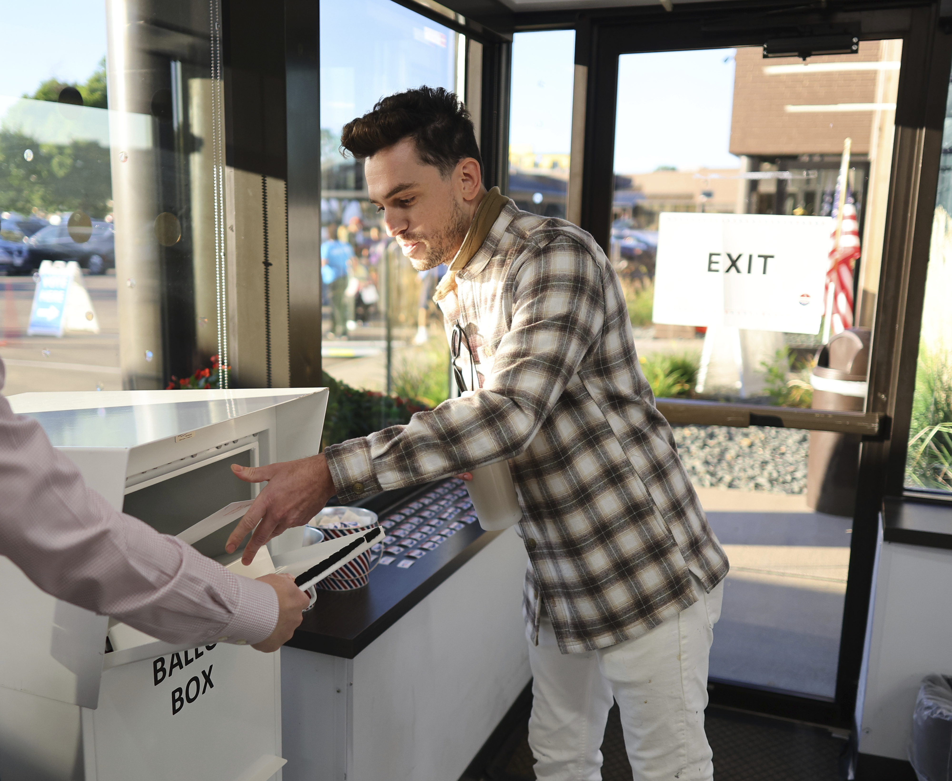 Minneapolis voter Jason Miller casts his ballot at the City of Minneapolis early voting center, Friday, September 20, 2024, in Minneapolis, Minn. Miller was the first resident in line to cast his vote. (AP Photo/Adam Bettcher)