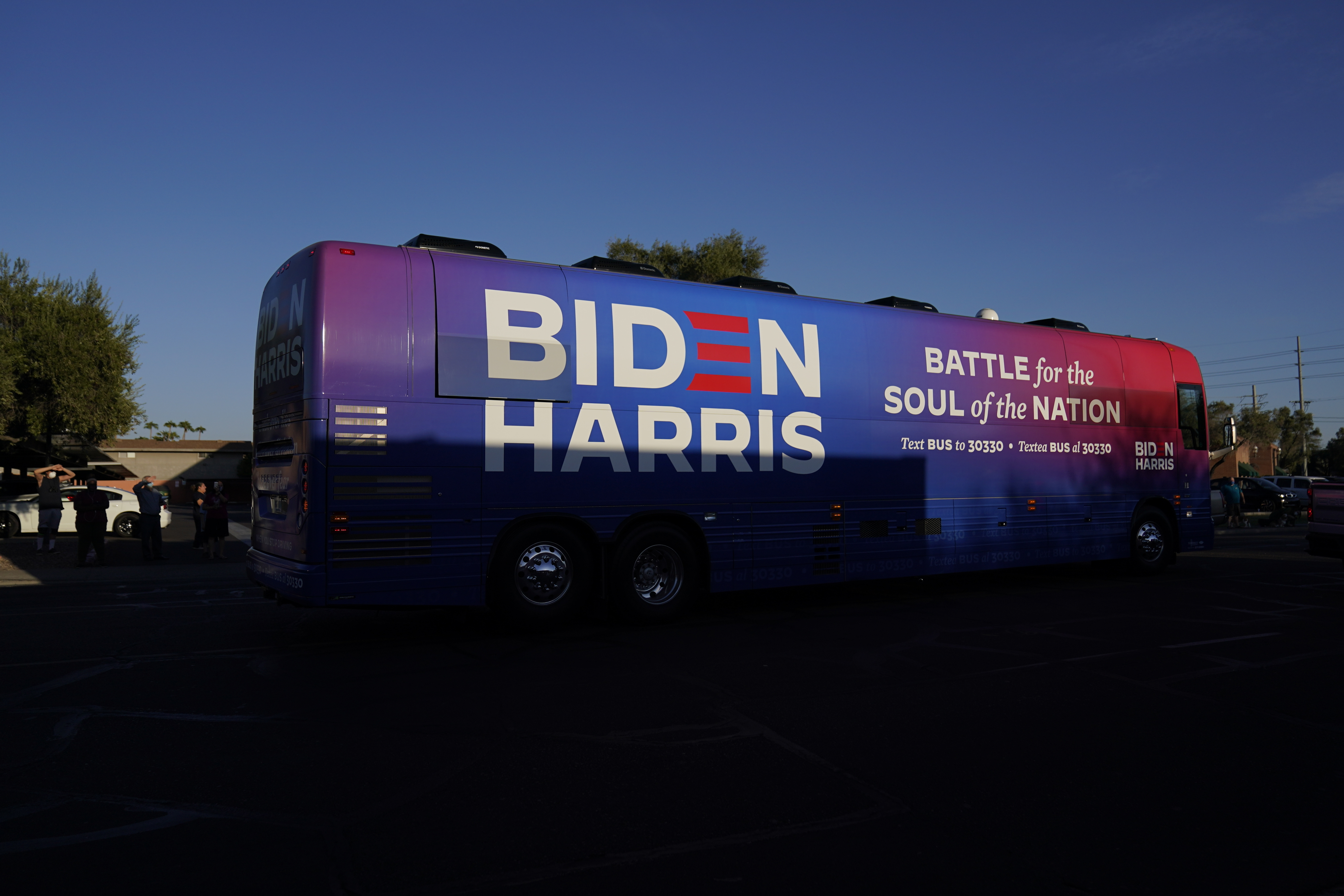 FILE - Democratic presidential candidate former Vice President Joe Biden and Democratic vice presidential candidate Sen. Kamala Harris, D-Calif., ride on a bus in Phoenix, Oct. 8, 2020, on a small business bus tour. (AP Photo/Carolyn Kaster, File)