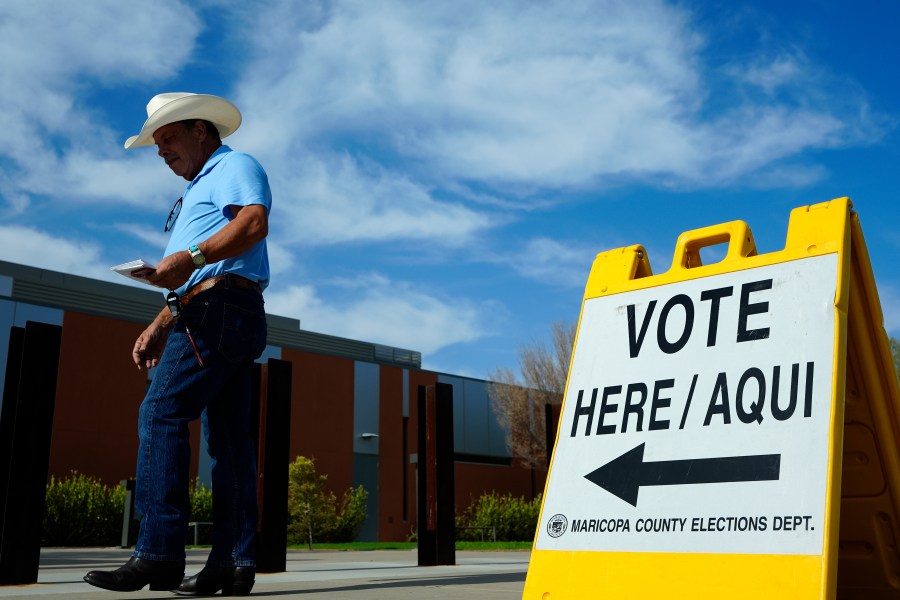 FILE - A voter walks to a voting precinct prior to casting his ballot in the state's primary election, Tuesday, July 30, 2024, in El Mirage, Ariz. (AP Photo/Ross D. Franklin, File)