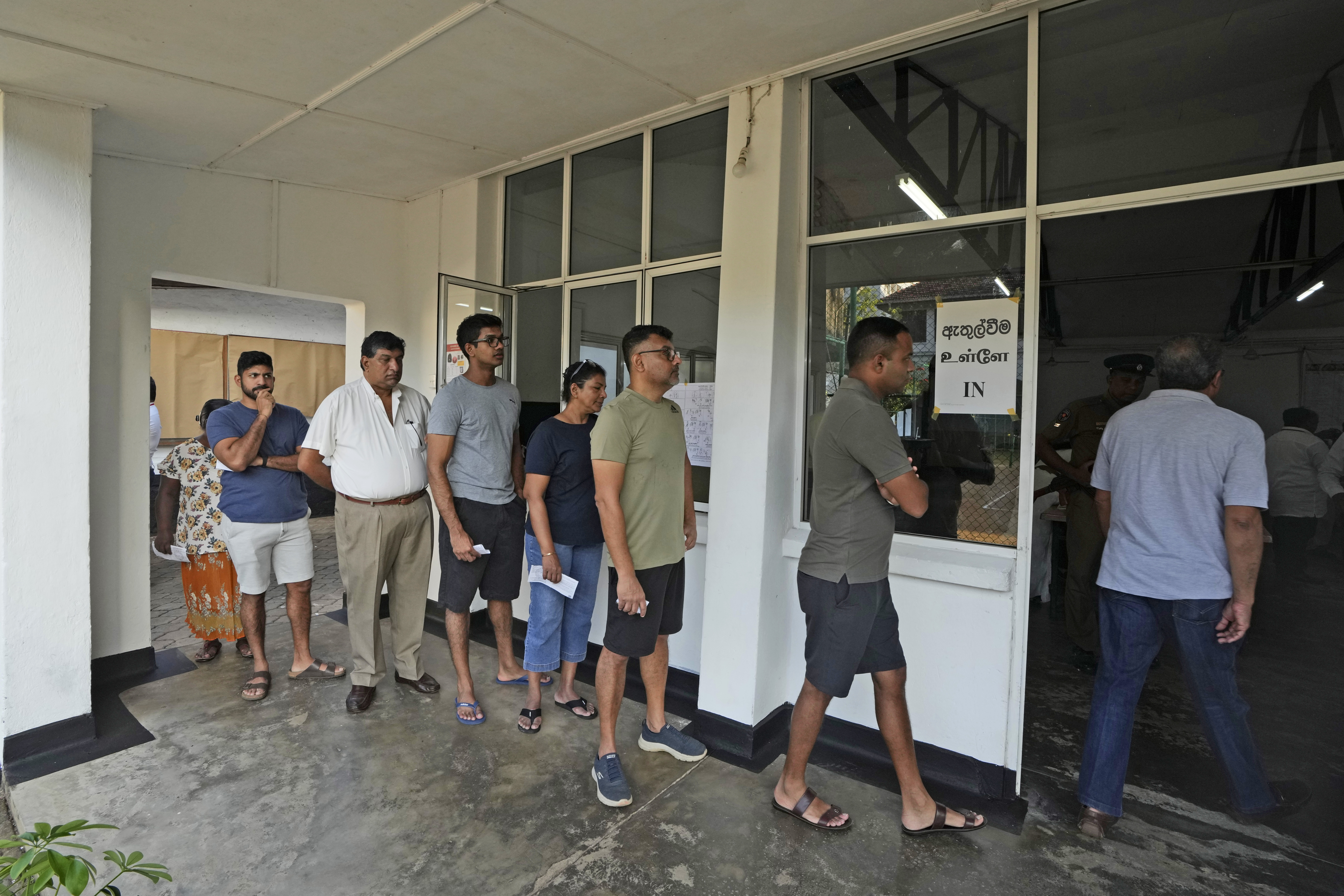 People wait in a queue to casts their votes at a polling station in Colombo, Sri Lanka, Saturday, Sept. 21, 2024. (AP Photo/Rajesh Kumar Singh)