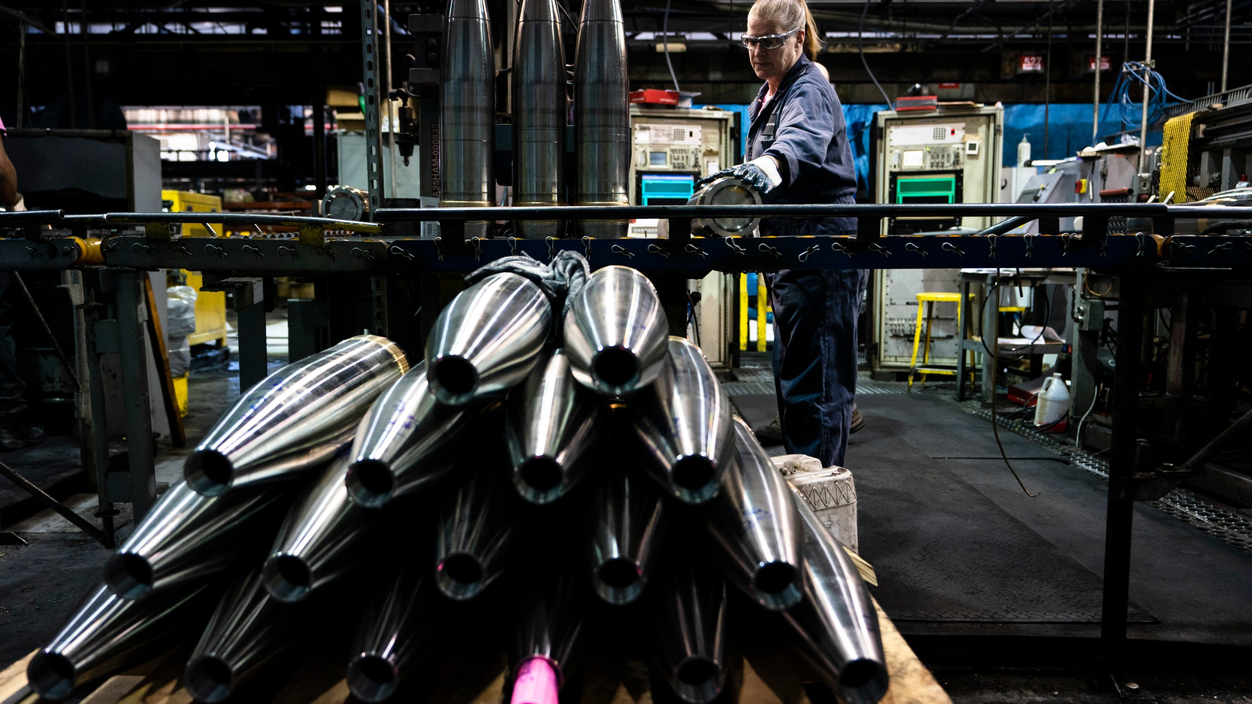 FILE -A steel worker moves a 155 mm M795 artillery projectile during the manufacturing process at the Scranton Army Ammunition Plant in Scranton, Pa., Thursday, April 13, 2023. (AP Photo/Matt Rourke, File)