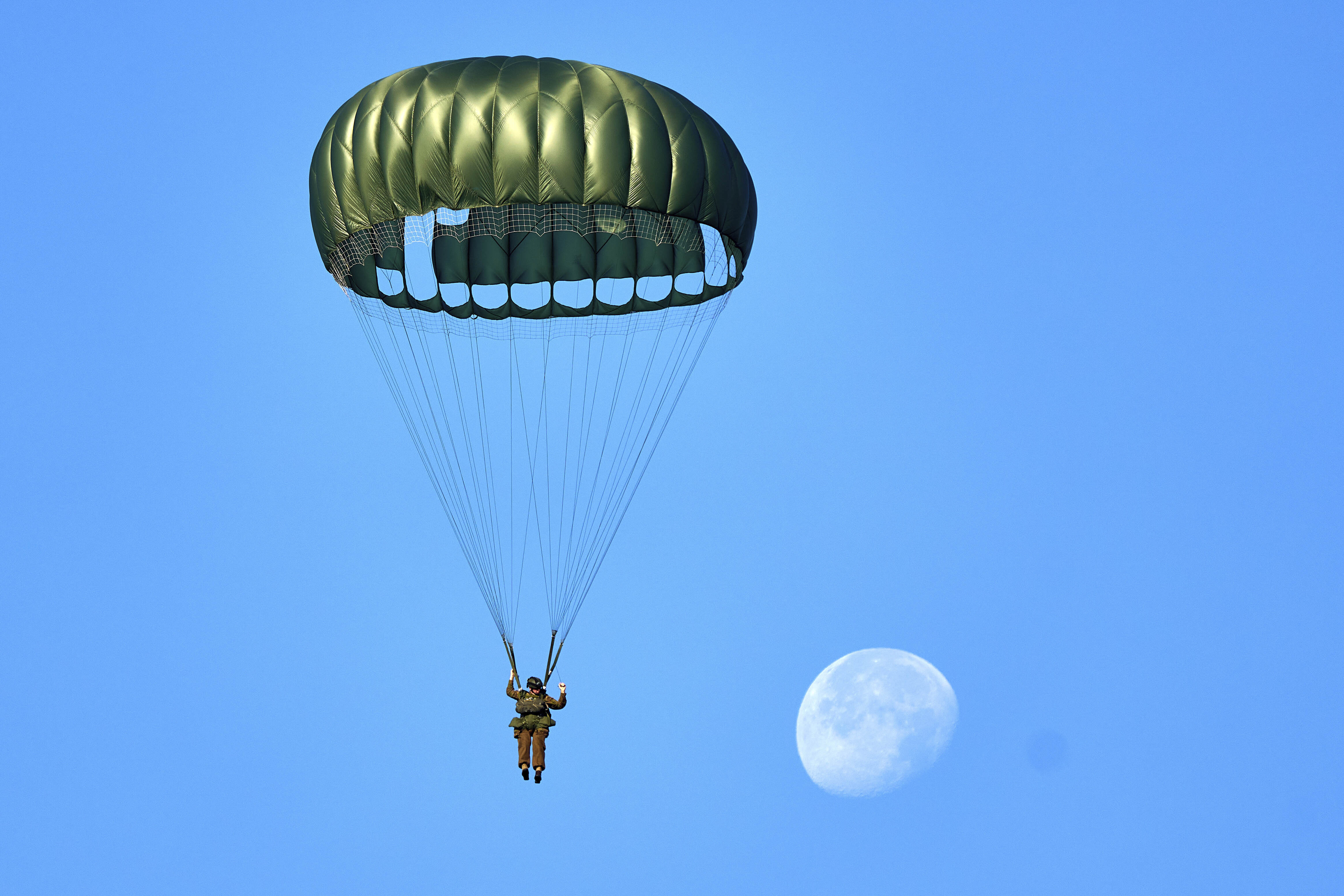 Parachutists jump over Ginkel Heath Netherlands, Saturday, Sept. 21, 2024, to mark the 80th anniversary of an audacious by unsuccessful World War II mission codenamed Market Garden to take key bridges in the Netherlands. (AP Photo/Phil Nijhuis)