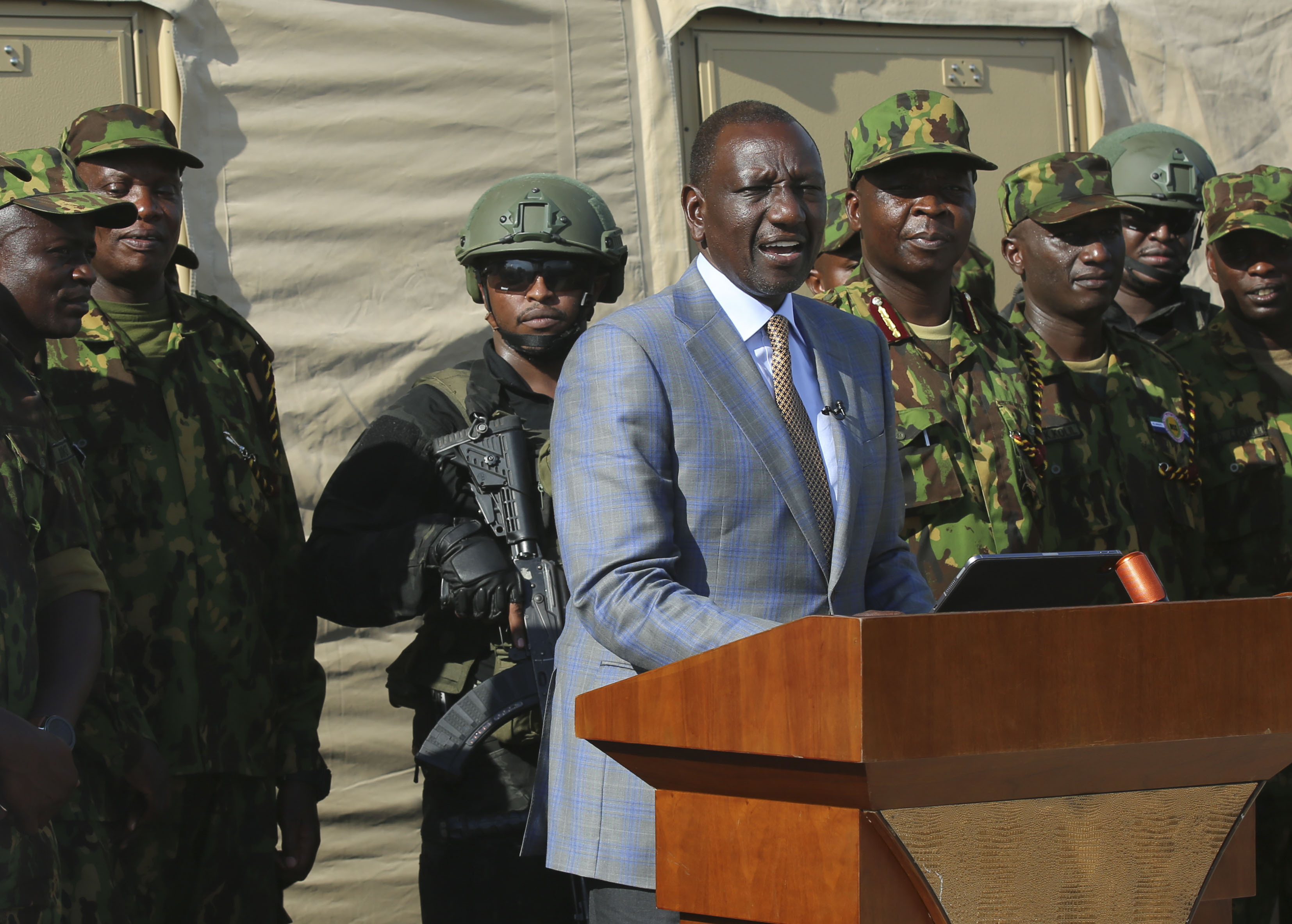 Kenya's President William Ruto speaks to Kenyan police officers, part of a UN-backed multinational force, during a visit to their base in Port-au-Prince, Haiti, Saturday, Sept. 21, 2024. (AP Photo/Odelyn Joseph)