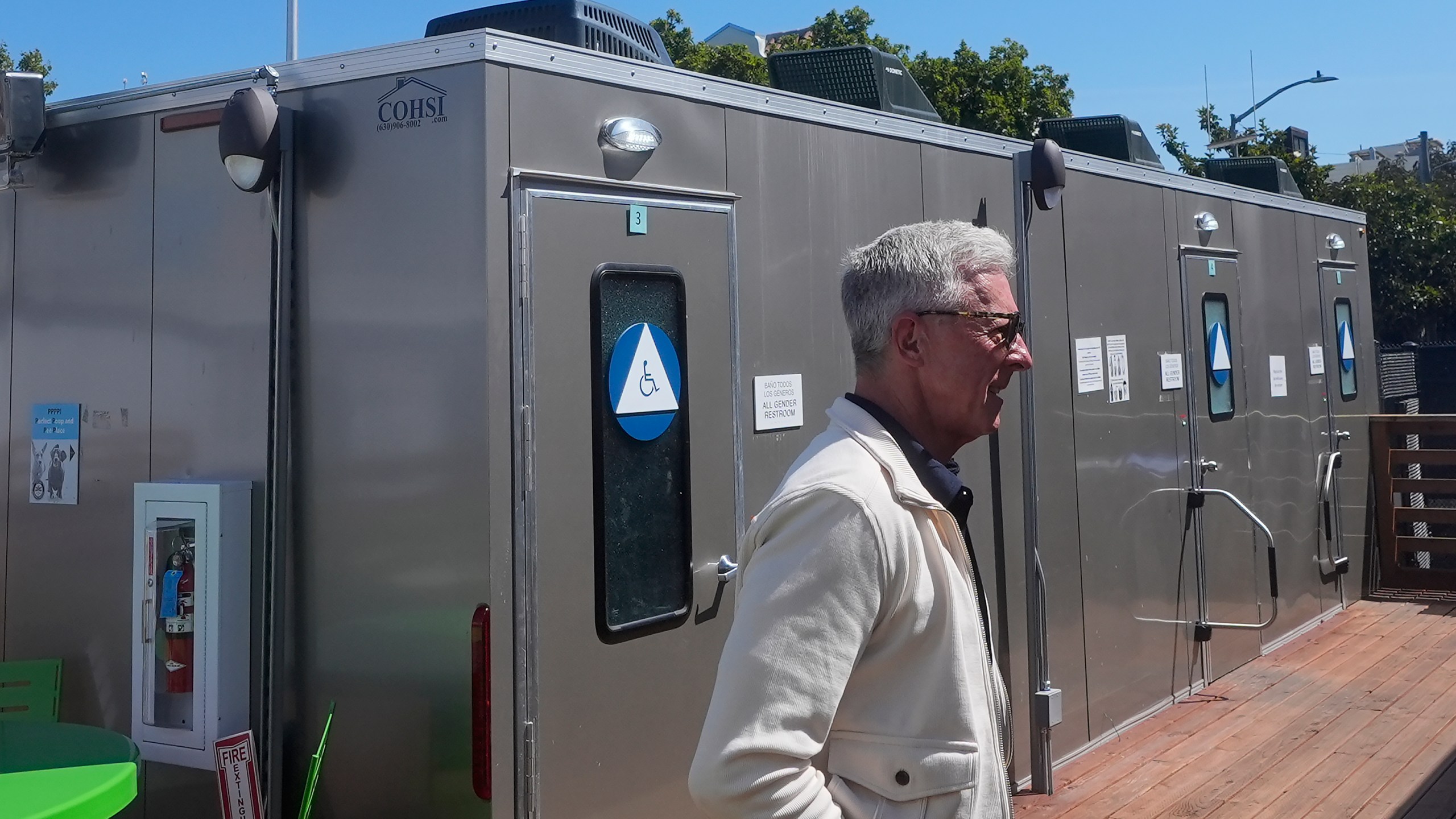 Steve Good, CEO of Five Keys, walks past restrooms at the Five Keys' Mission Cabins transitional housing location in San Francisco, Monday, Aug. 26, 2024. (AP Photo/Jeff Chiu)