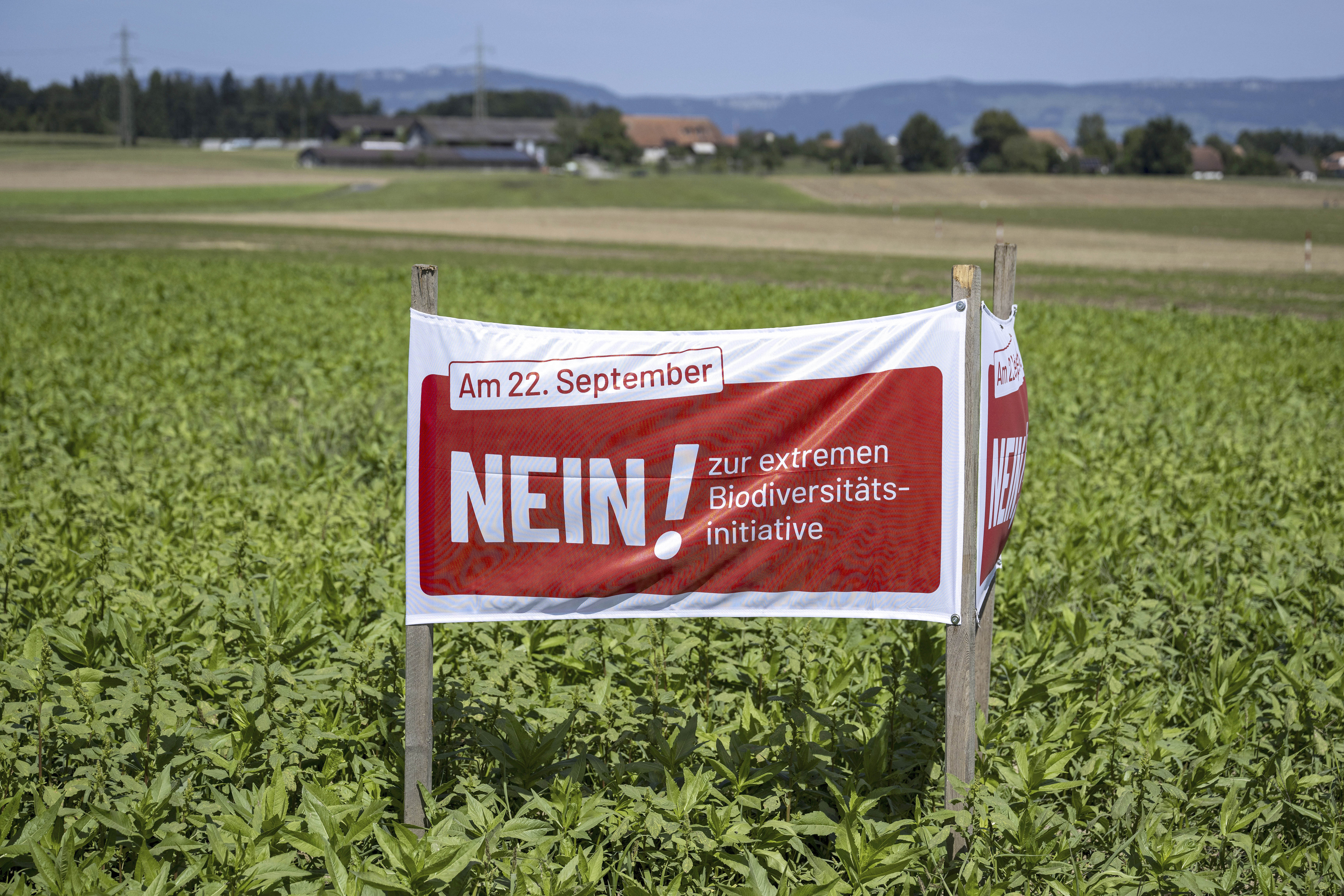 A poster for the No campaign ahead of a biodiversity referendum due to take place on Sept. 22, is seen in a field in Hoechstetten, Switzerland, Friday, Aug. 23, 2024, (Peter Schneider/Keystone via AP)