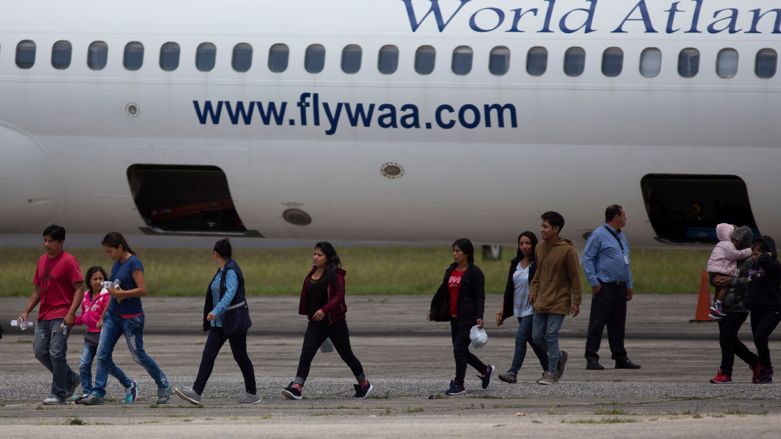 FILE - In this Aug. 20, 2019, file photo, Guatemalans who were deported from the United States arrive to La Aurora International airport in Guatemala City. (AP Photo/Moises Castillo, File)