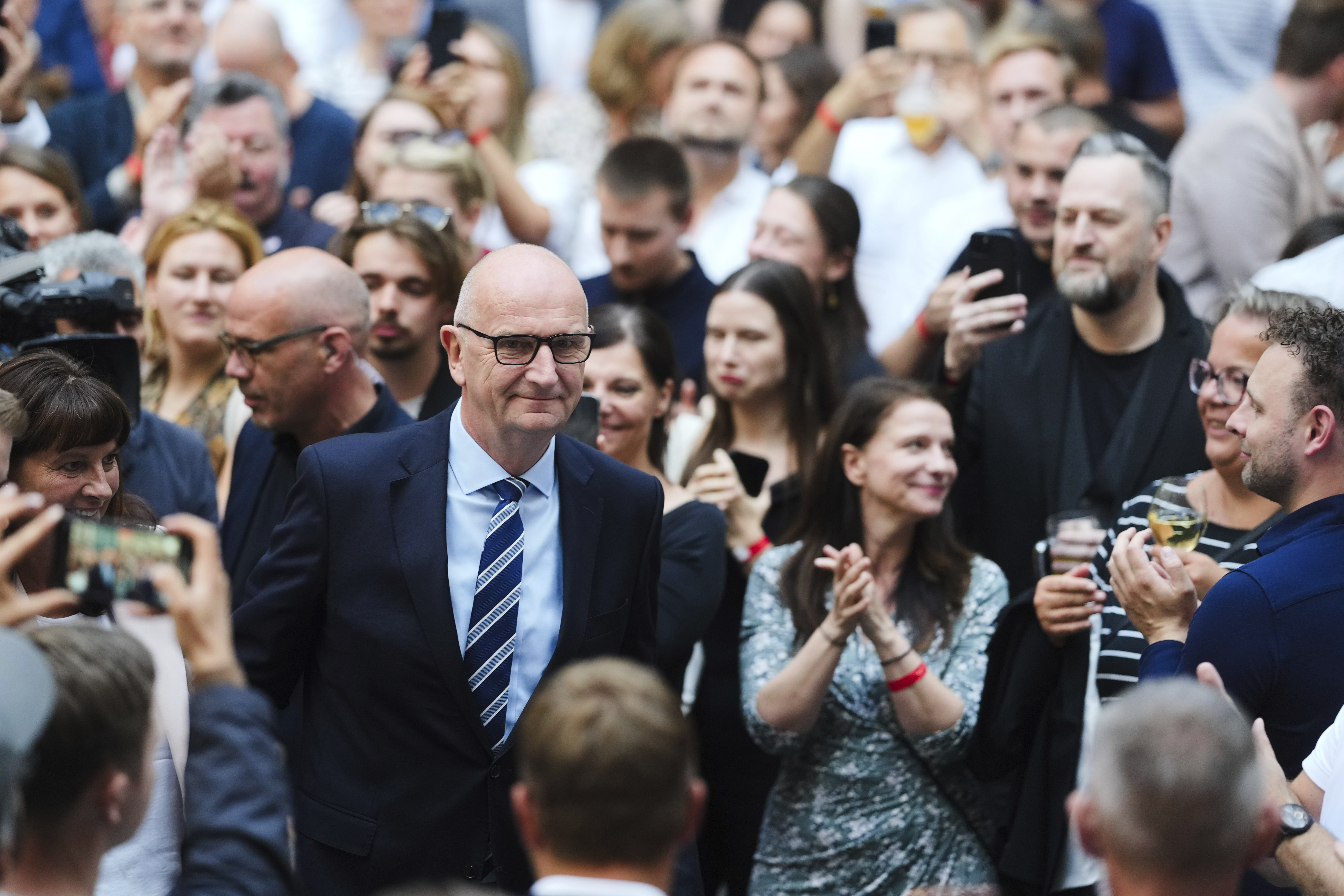 Governor of Brandenburg and Germany's Social Democratic Party, SPD, for the state election Dietmar Woidke, center, arrives at the party's election event after first exit polls announced in Potsdam, Germany, Sunday, Sept. 22, 2024. (AP Photo/Markus Schreiber)