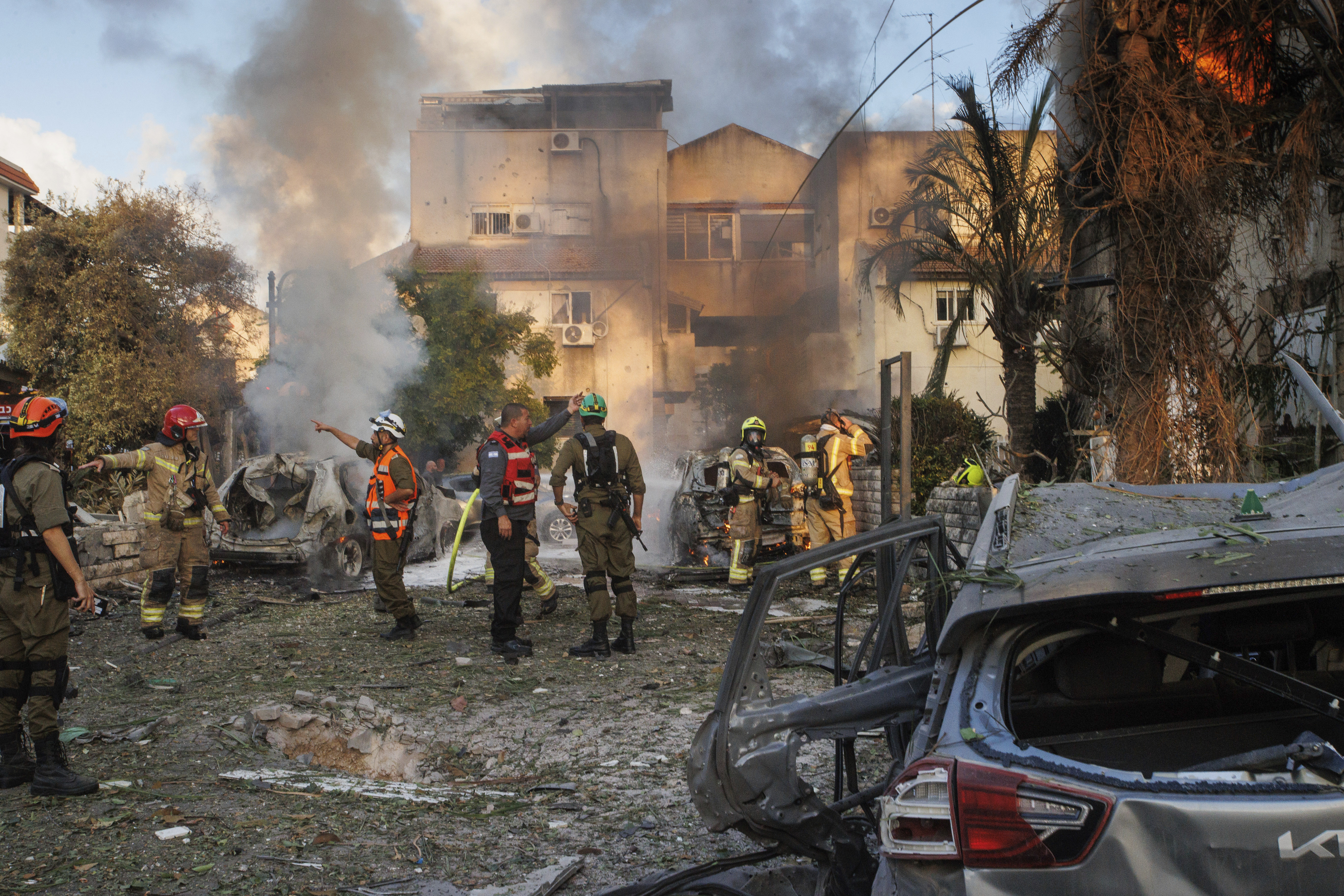 Israeli security forces work at the site hit by a rocket fired from Lebanon, in Kiryat Bialik, northern Israel, on Sunday, Sept. 22, 2024. (AP Photo/Gil Nechushtan)