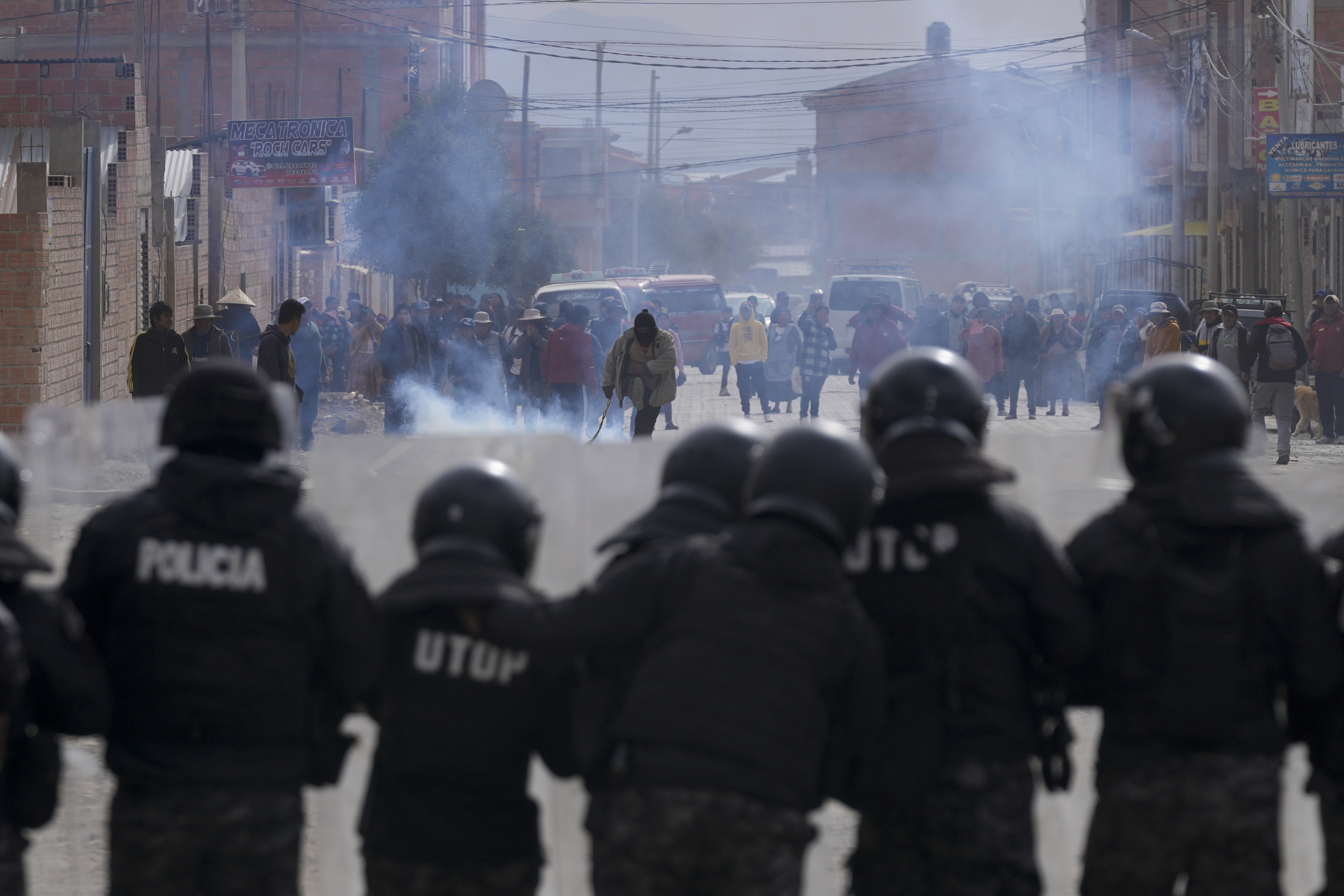 Police stand in front of supporters of former President Evo Morales in El Alto, Bolivia, Sunday, Sept. 22, 2024. (AP Photo/Juan Karita)