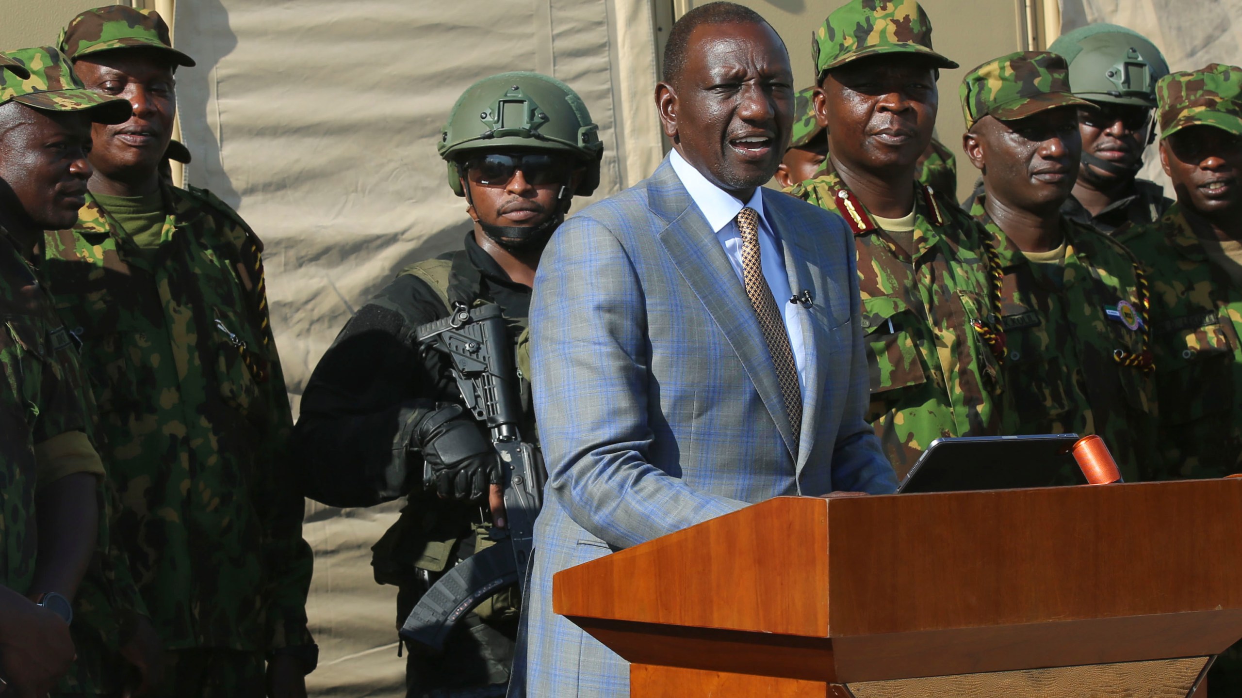 Kenya's President William Ruto speaks to Kenyan police officers, part of a UN-backed multinational force, during a visit to their base in Port-au-Prince, Haiti, Saturday, Sept. 21, 2024. (AP Photo/Odelyn Joseph)