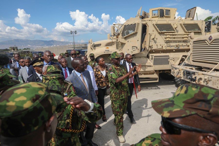 Kenya's President William Ruto, center left, visits Kenyan police, part of a UN-backed multinational force, at their base in Port-au-Prince, Haiti, Saturday, Sept. 21, 2024. (AP Photo/Odelyn Joseph)