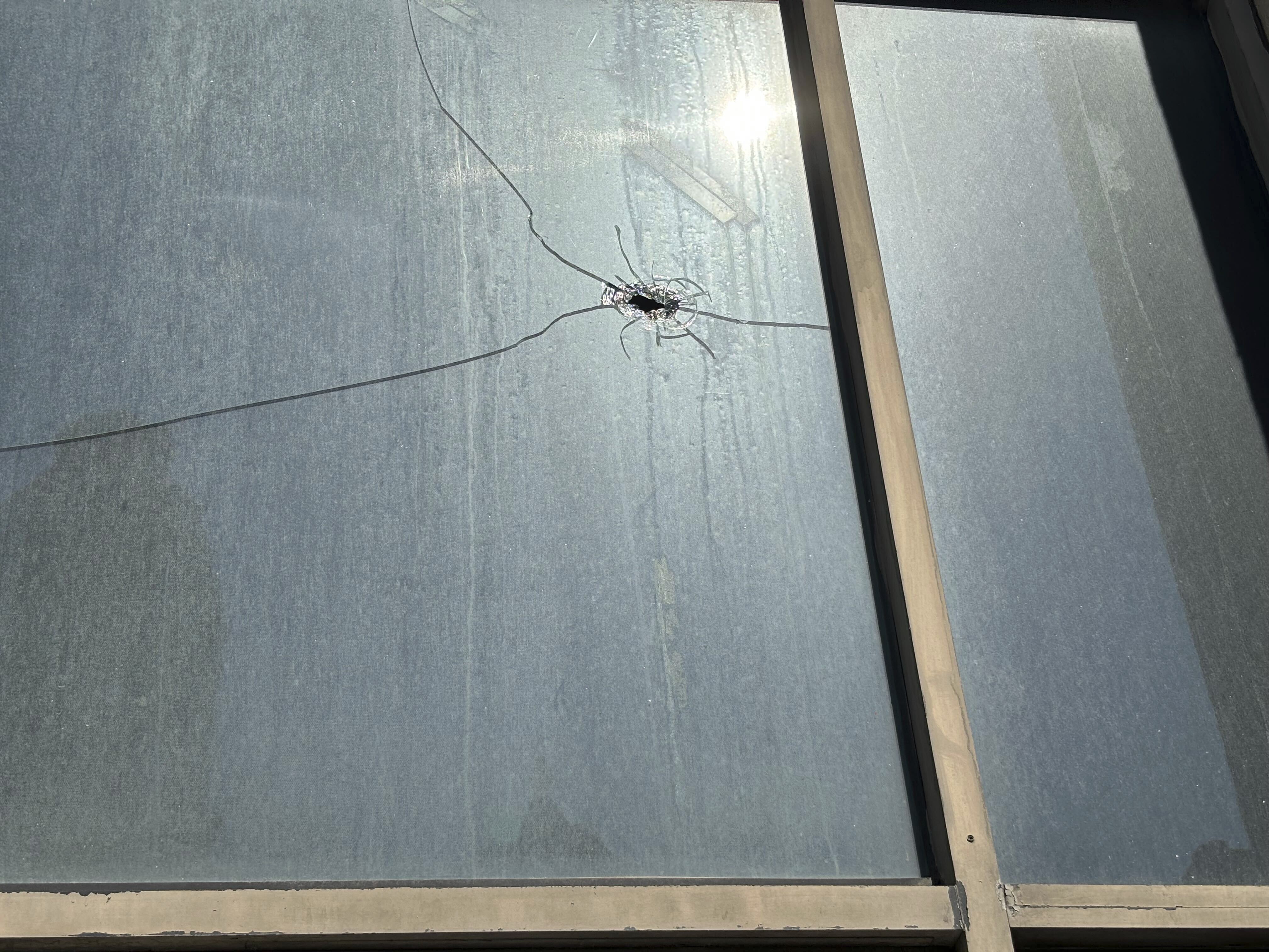 CORRECTS DATE hat appears to be a bullet hole is visible in the window of Hush, a hookah and cigar lounge, in Birmingham, Ala. on Sunday, Sept. 22, 2024, the day after a mass shooting took place. (AP Photo/Kim Chandler)