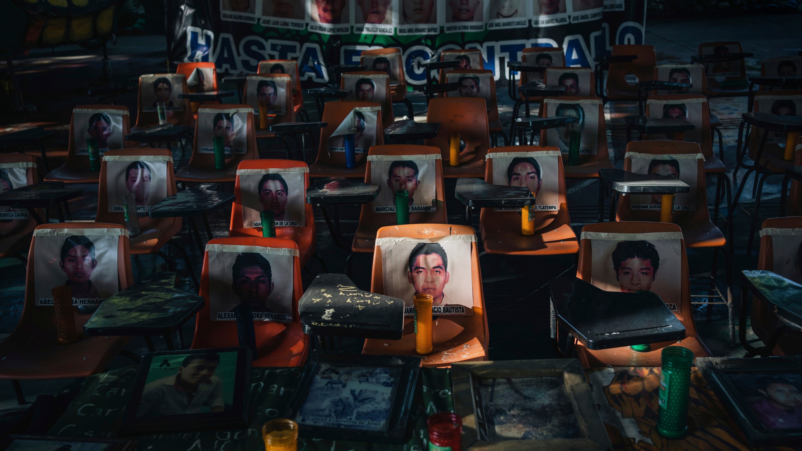 Photos of 43 students who have been missing for 10 years cover the stairs at their former Raúl Isidro Burgos Rural Normal School in Ayotzinapa, Guerrero state, Mexico, Saturday, Aug. 24, 2024. (AP Photo/Felix Marquez)