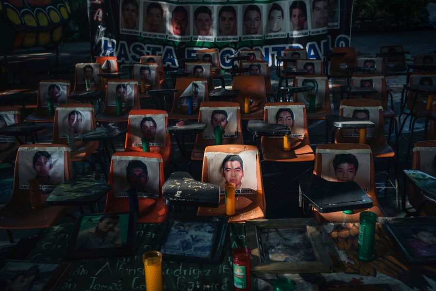 Photos of 43 students who have been missing for 10 years cover the stairs at their former Raúl Isidro Burgos Rural Normal School in Ayotzinapa, Guerrero state, Mexico, Saturday, Aug. 24, 2024. (AP Photo/Felix Marquez)