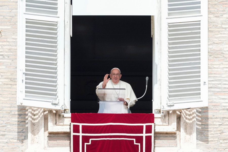 Pope Francis waves during the Angelus noon prayer from the window of his studio overlooking St.Peter's Square, at the Vatican, Sunday, Sept. 22, 2024. (AP Photo/Alessandra Tarantino)