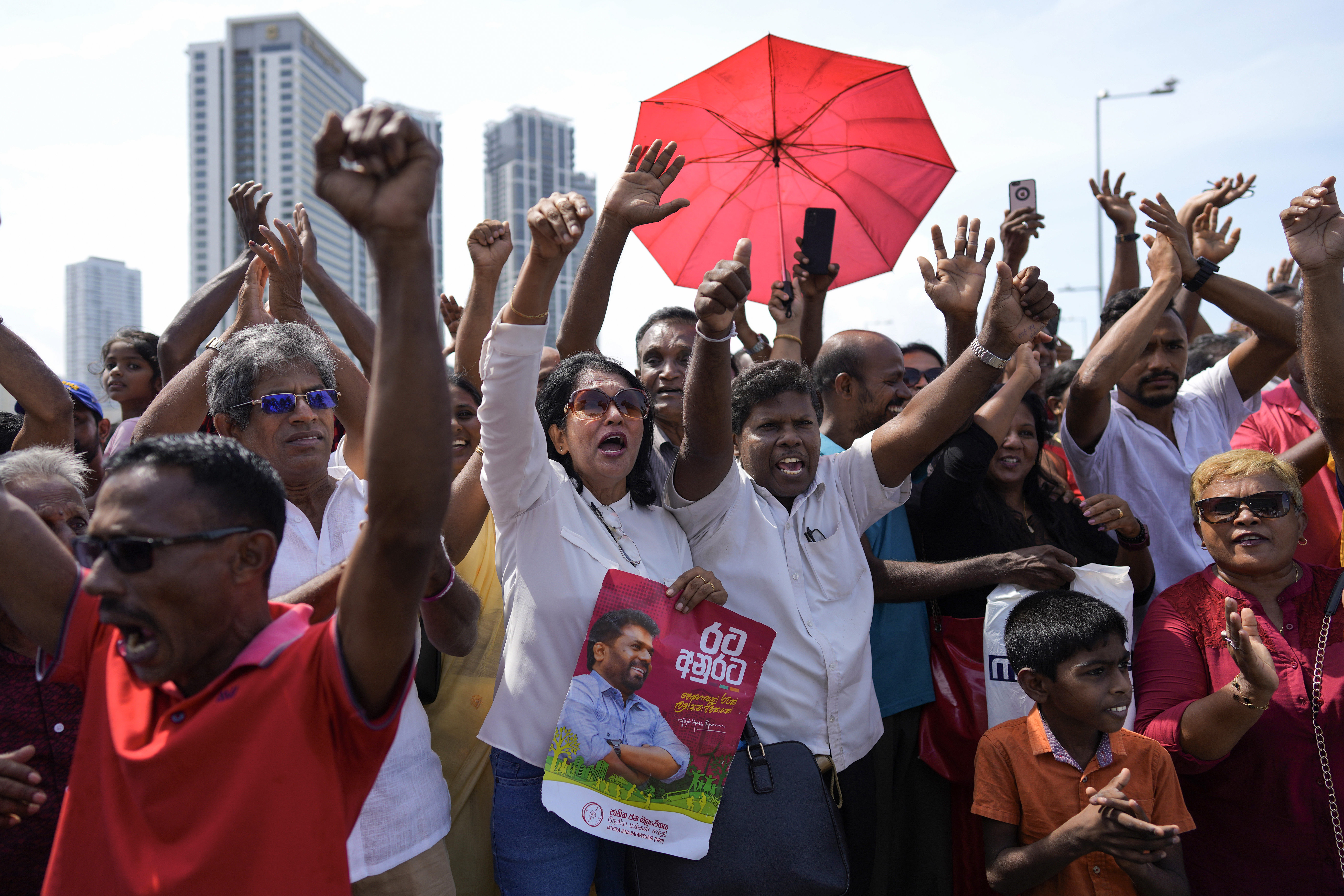 Supporters of Marxist lawmaker Anura Kumara Dissanayake cheer outside the president's office as he arrives to be sworn in as Sri Lanka’s tenth president in Colombo, Sri Lanka, Monday, Sept. 23, 2024. (AP Photo/Eranga Jayawardena)