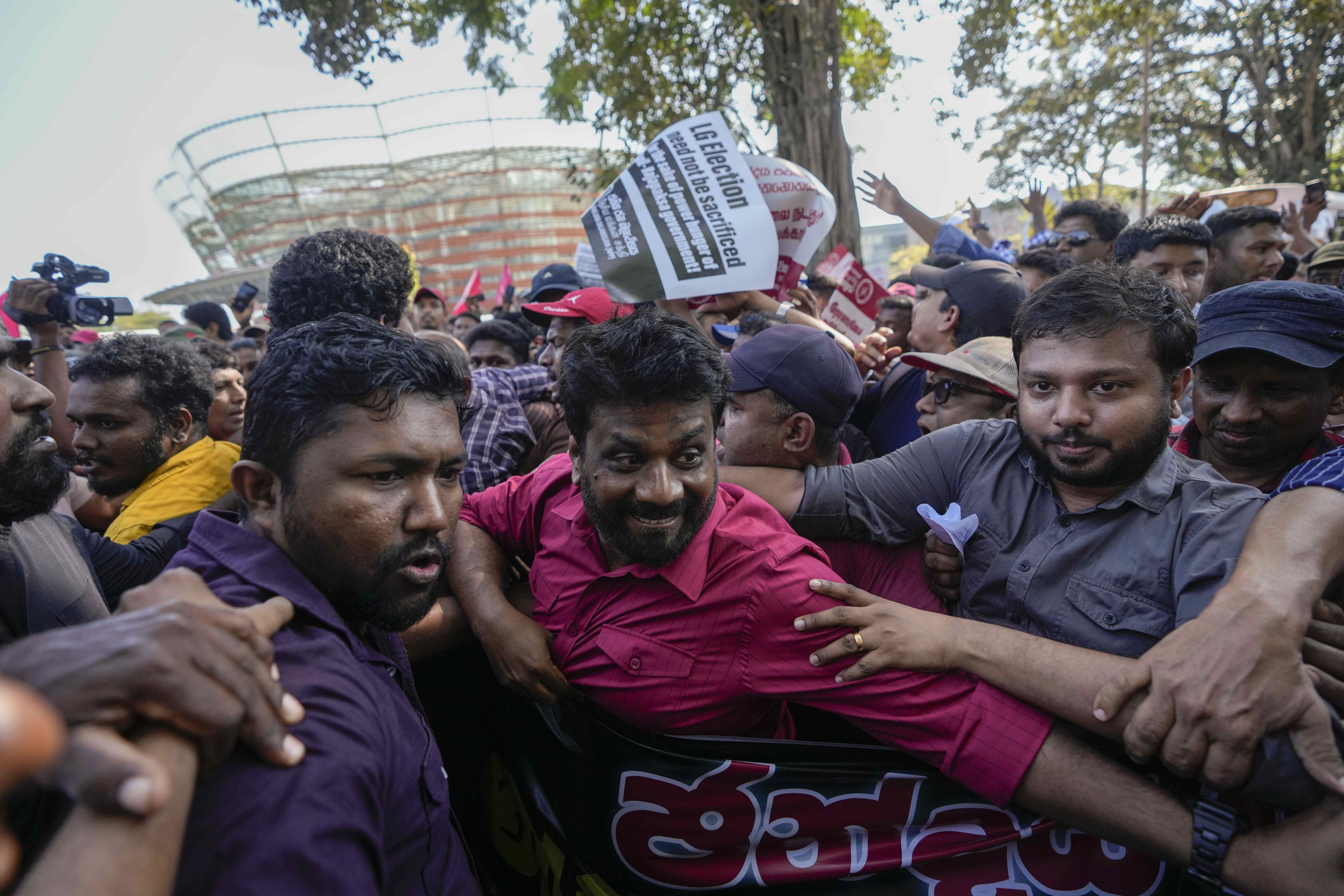 FILE -Anura Kumara Dissanayake, center, leader of opposition political party National People's Power attends a protest rally in Colombo, Sri Lanka, Feb. 26, 2023. (AP Photo/Eranga Jayawardena, File)