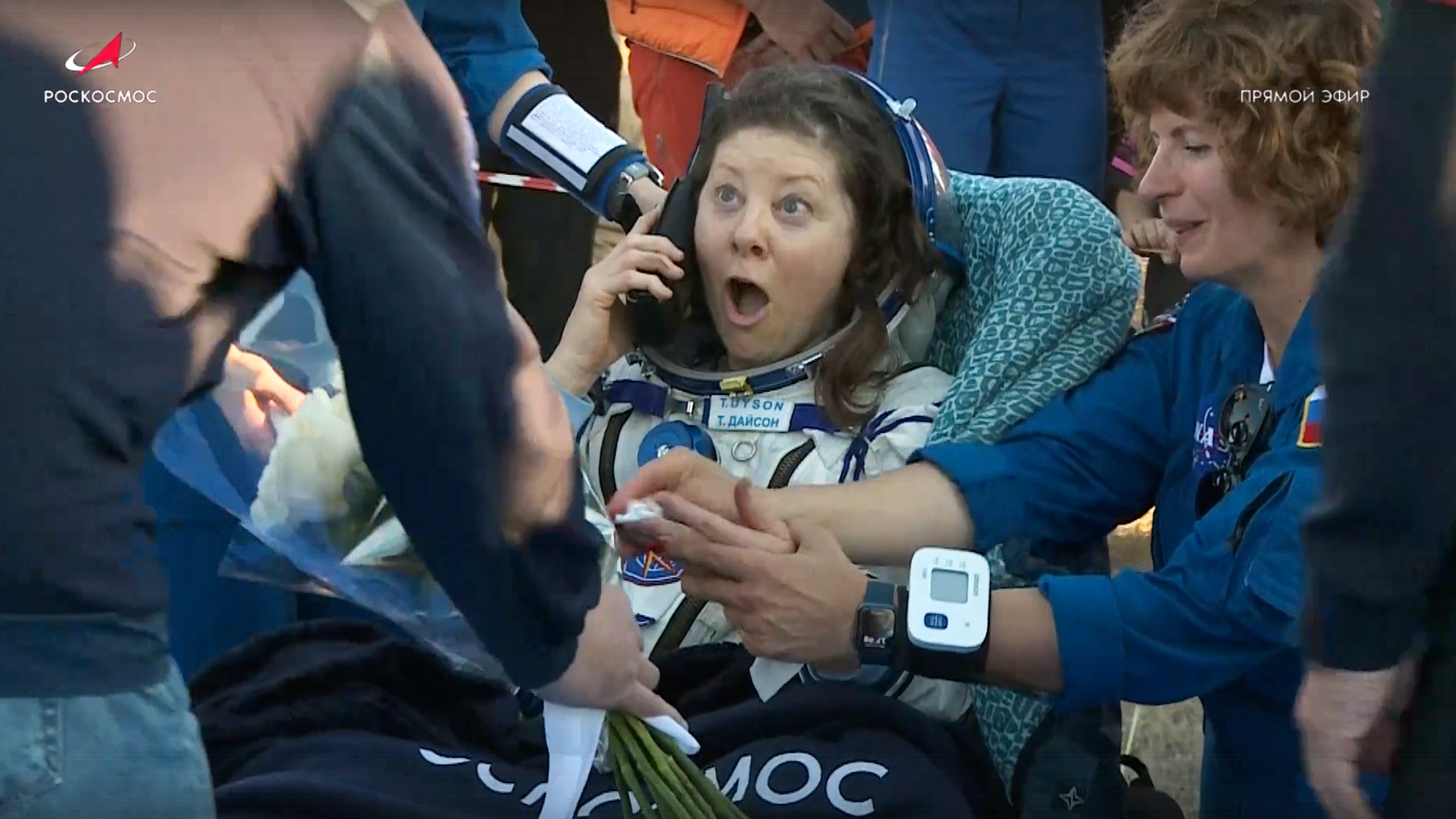 In this photo taken from video released by Roscosmos space corporation, the NASA astronaut Tracy Dyson is gifted with flowers shortly after the landing of the Russian Soyuz MS-25 space capsule carrying the NASA astronaut Tracy Dyson and the Roscosmos cosmonauts Oleg Kononenko and Nikolai Chub, south-east of the Kazakh town of Zhezkazgan, Kazakhstan, Monday, Sept. 23, 2024. (Roscosmos space corporation via AP)