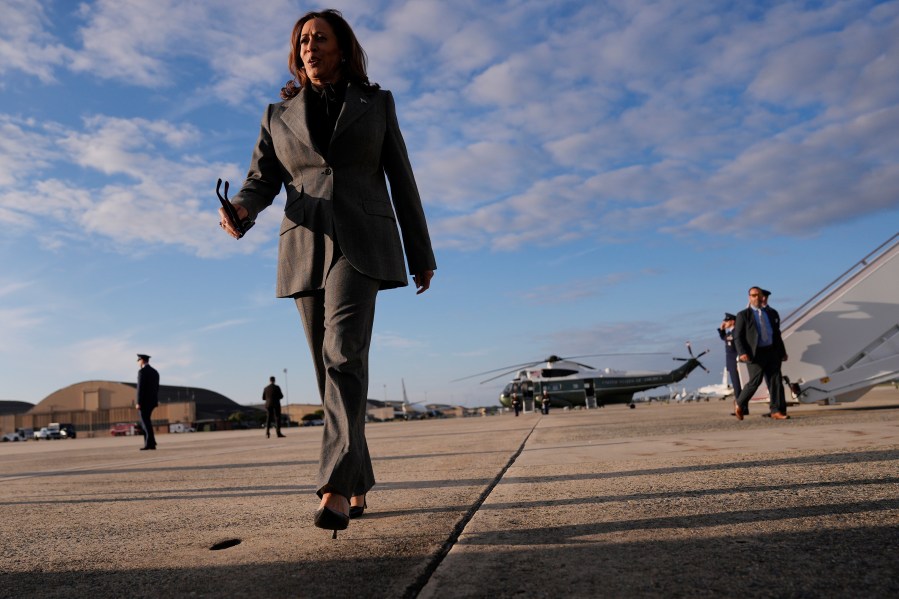 Democratic presidential nominee Vice President Kamala Harris walks over to speak to members of the media upon her arrival at Andrews Air Force Base, Md., Sunday, Sept. 22, 2024. (AP Photo/Matt Rourke/Pool)