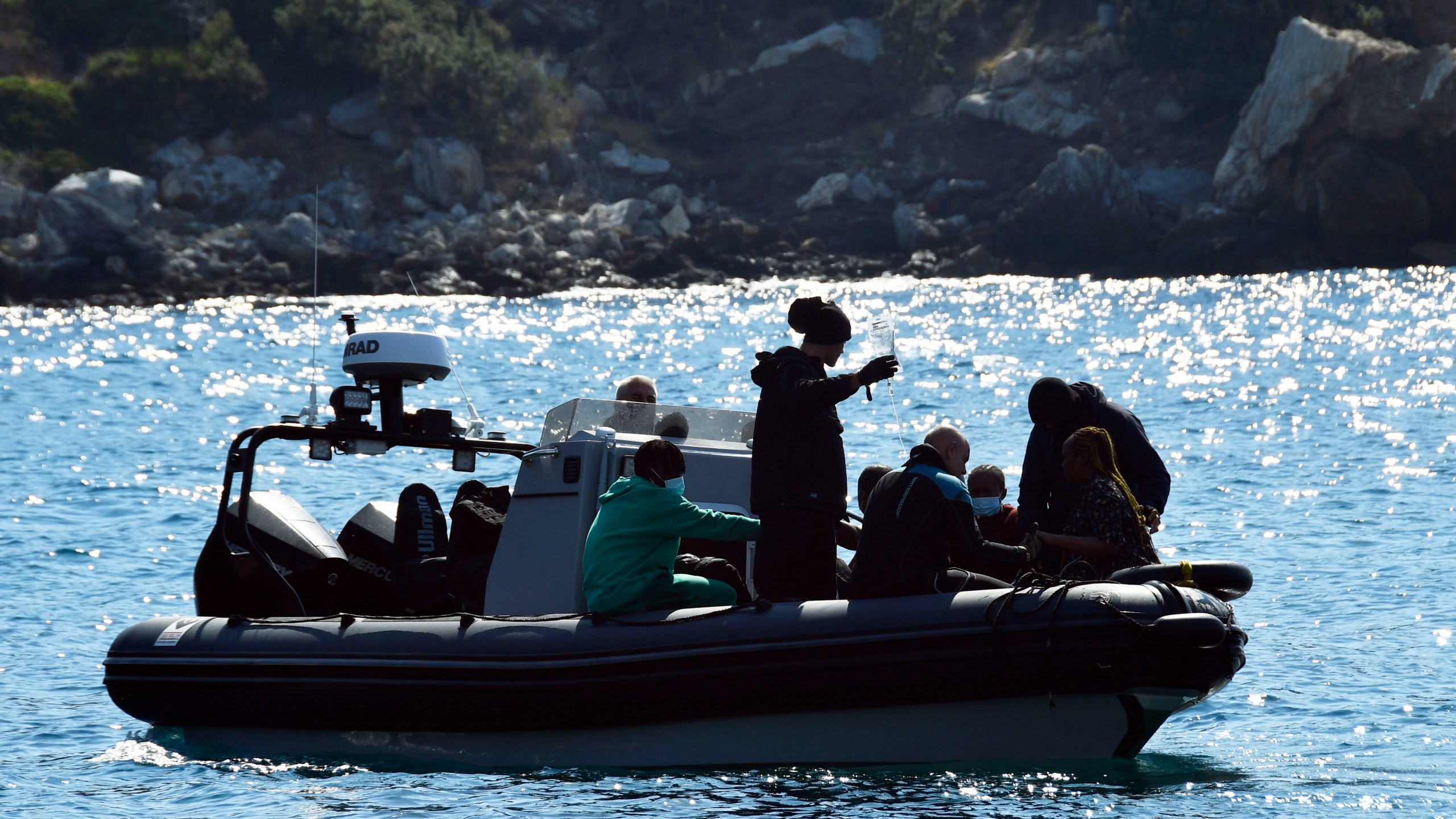 Survivors sit on a vessel after a boat carrying migrants ran into trouble off the coast of the eastern Aegean Sea island of Samos, Greece, on Monday, Sept. 23, 2024. (AP Photo/Michael Svarnias)