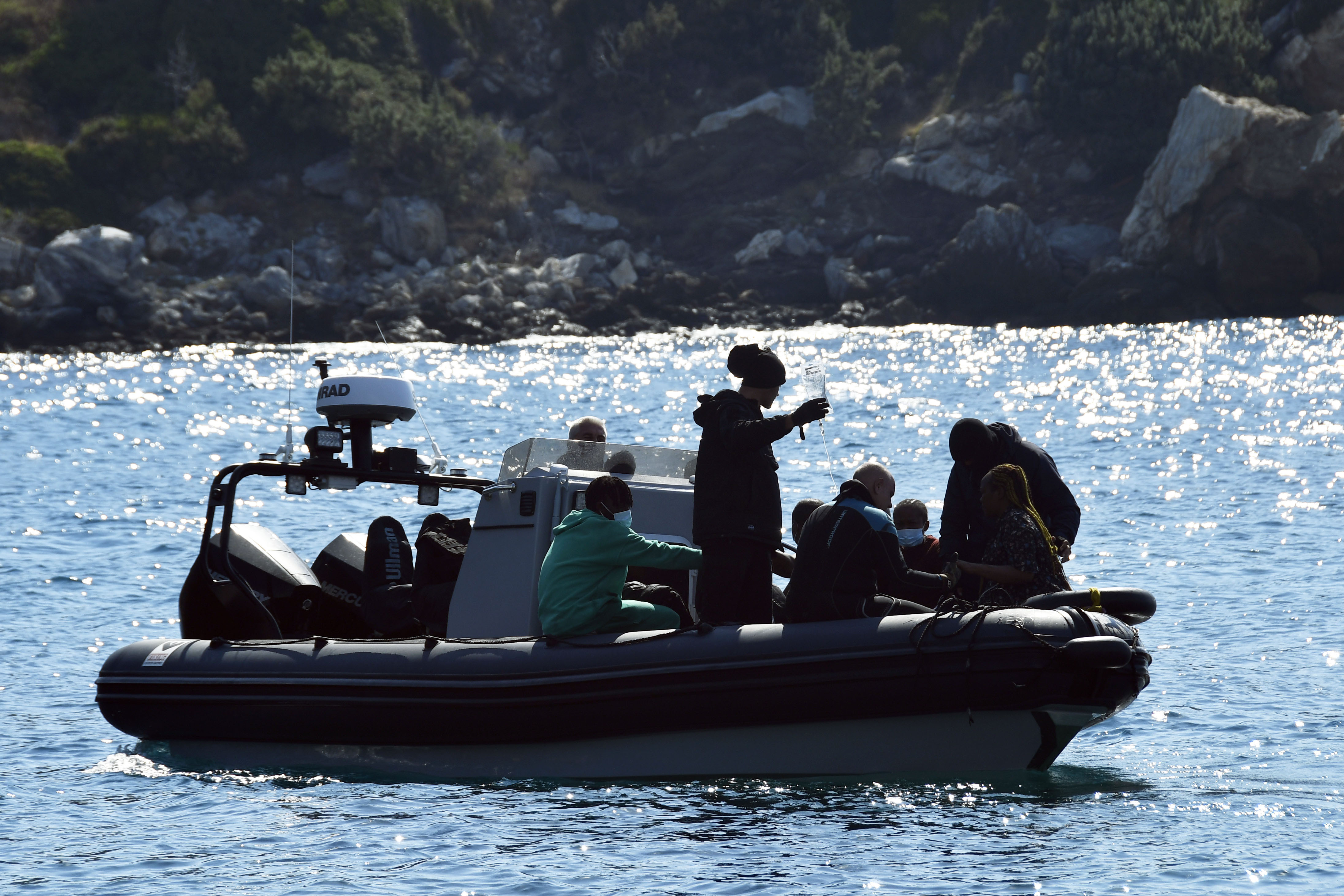 Survivors sit on a vessel after a boat carrying migrants ran into trouble off the coast of the eastern Aegean Sea island of Samos, Greece, on Monday, Sept. 23, 2024. (AP Photo/Michael Svarnias)