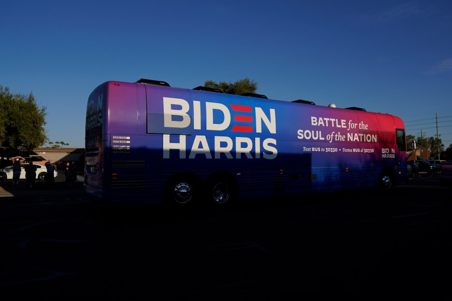 FILE - Democratic presidential candidate former Vice President Joe Biden and Democratic vice presidential candidate Sen. Kamala Harris, D-Calif., ride on a bus in Phoenix, Oct. 8, 2020, on a small business bus tour. (AP Photo/Carolyn Kaster, File)