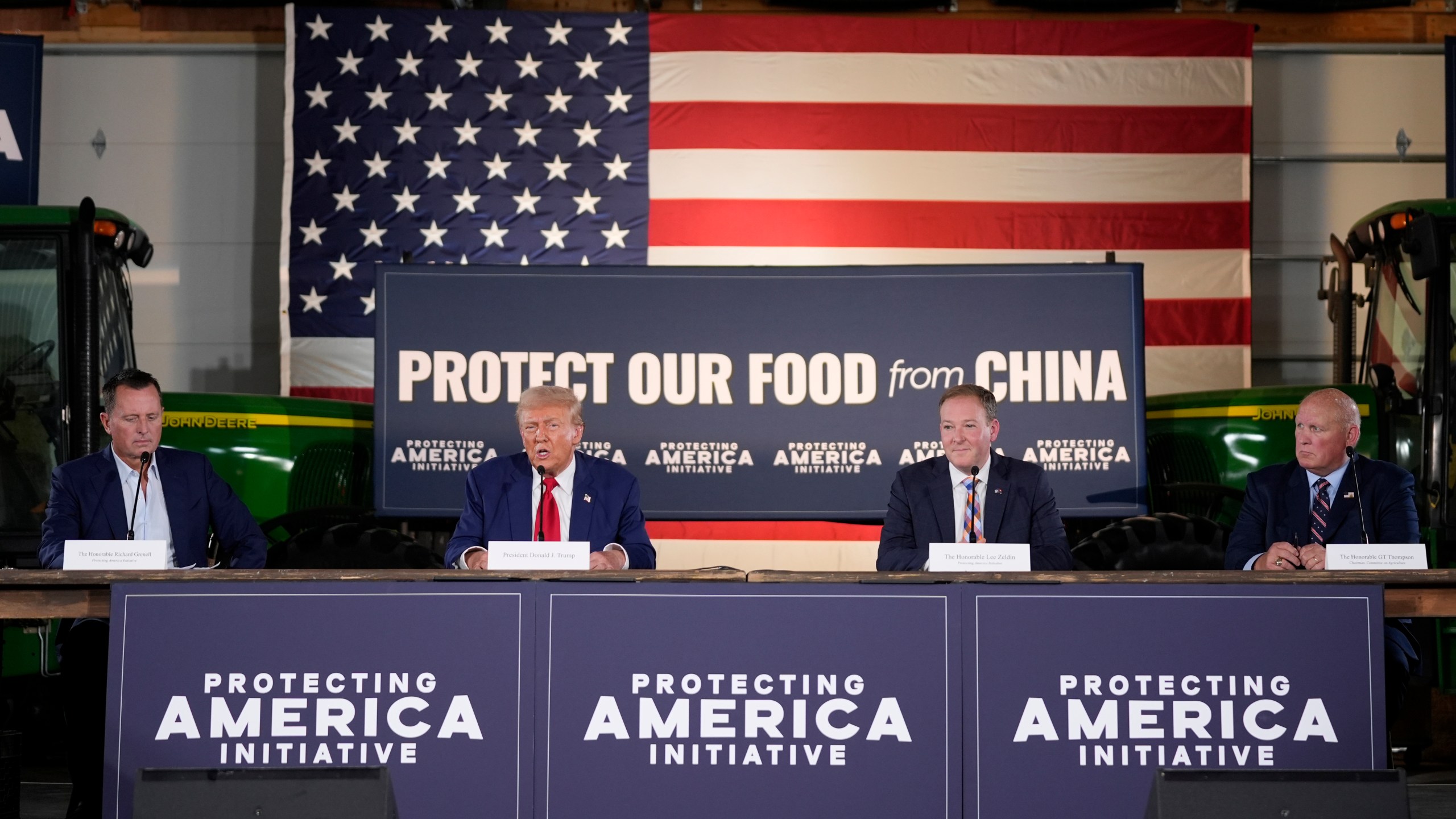 Republican presidential nominee former President Donald Trump speaks at a campaign event at a farm, Monday, Sept. 23, 2024, in Smithton, Pa, as from left, Richard Grenell, Lee Zeldin and Rep. Glenn Thompson, R-Pa., listen. (AP Photo/Alex Brandon)