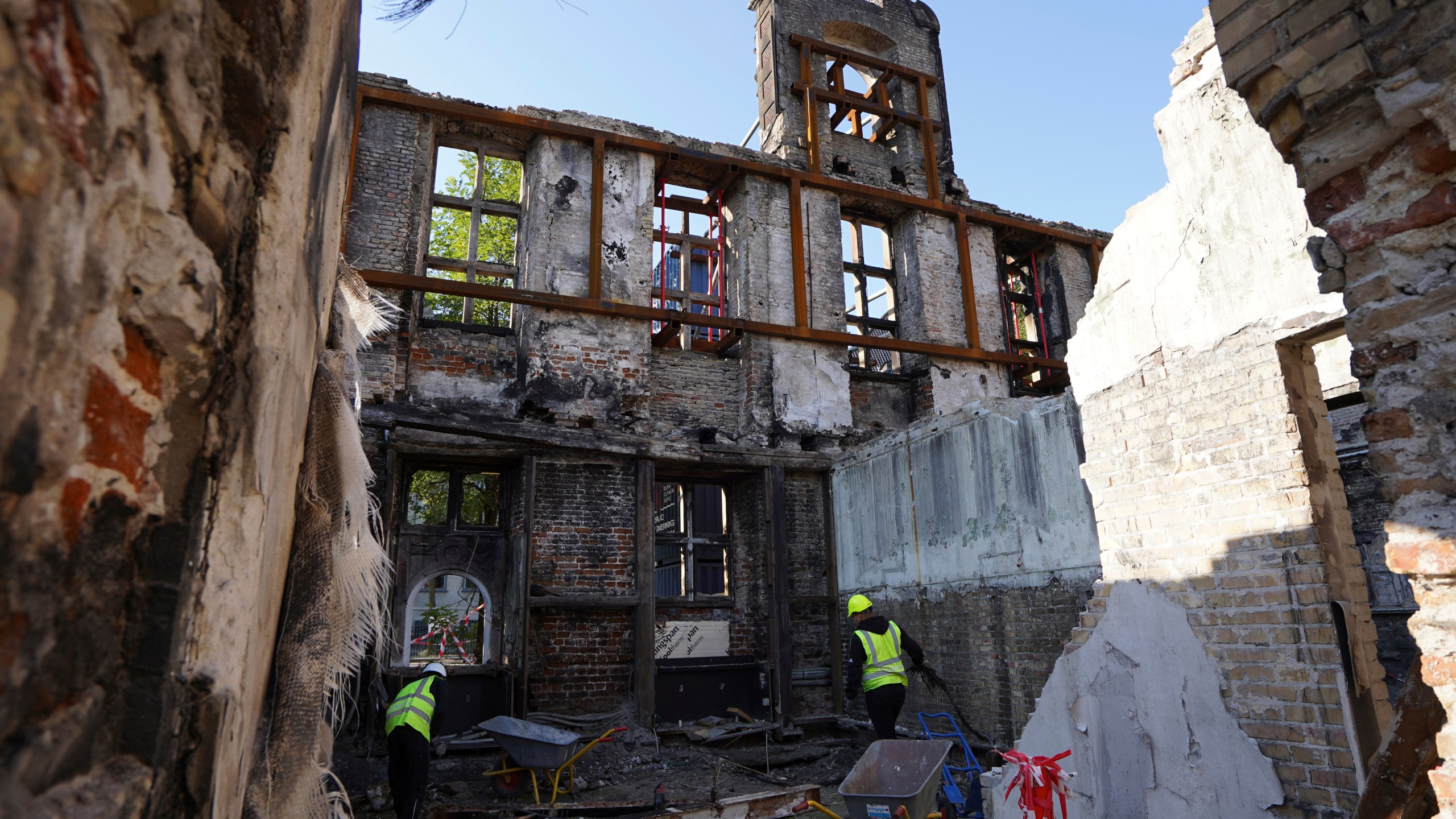 Workers clear rubble at Copenhagen's Old Stock Exchange building in Copenhagen, Denmark, Thursday, Sept. 19, 2024. (AP Photo James Brooks)