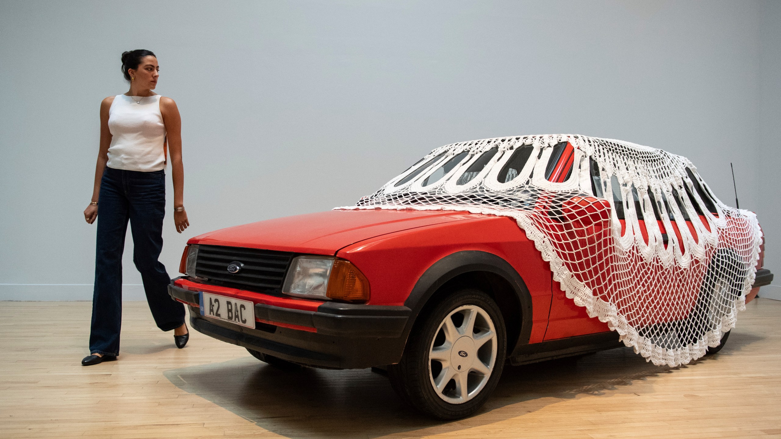 A woman passes by an artwork by Jasleen Kaur during the Turner Prize 2024 press preview at Tate Britain in London, part of the 40th anniversary exhibition featuring four shortlisted artists, Tuesday, Sept. 24, 2024. (AP Photo/Thomas Krych)