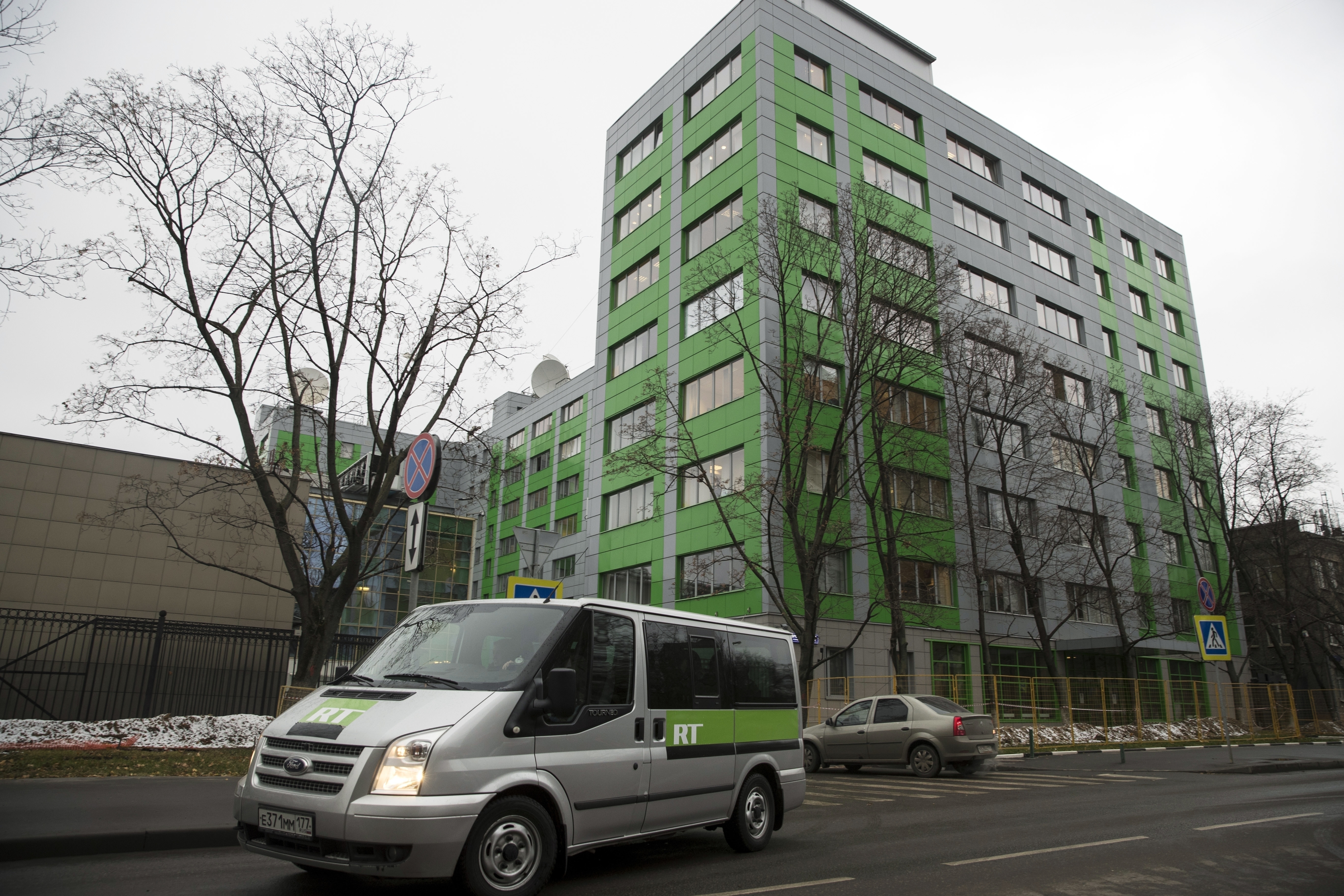 FILE - A car of Russian state-owned television station RT passes by the company's office on Oct. 27, 2017, in Moscow. (AP Photo/Pavel Golovkin, File)