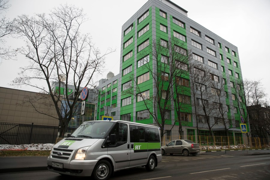 FILE - A car of Russian state-owned television station RT passes by the company's office on Oct. 27, 2017, in Moscow. (AP Photo/Pavel Golovkin, File)