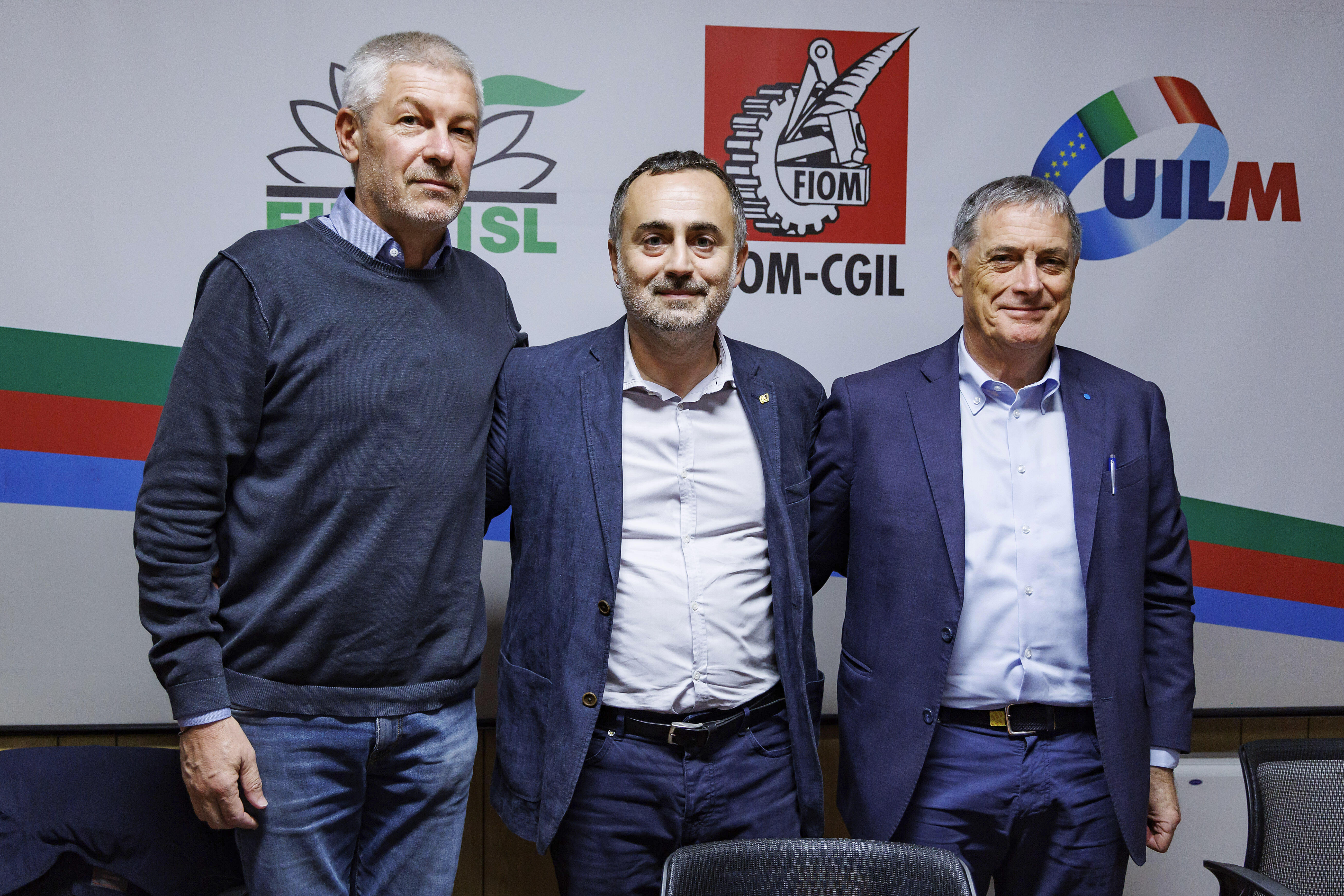 Fernando Uliano of Fim Cisl union, left, Michele De Palma of Fiom Cgil union, centre, and Rocco Palombella of Uilm union pose after announcing the mobilization of Stellantis workers and the entire automotive supply chain, in Rome, Tuesday, Sept. 24, 2024. (Roberto Monaldo/LaPresse via AP)